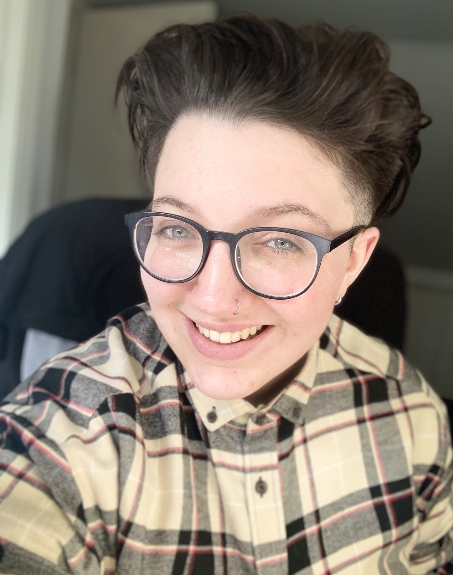 Jack Hyslop pictured in a selfie. He is wearing glasses and a chequered shirt.