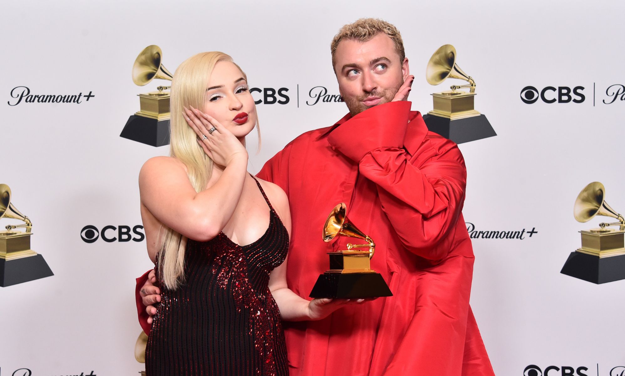 Kim Petras and Sam Smith pout and hold their Grammy award for &quot;Unholy&quot;.