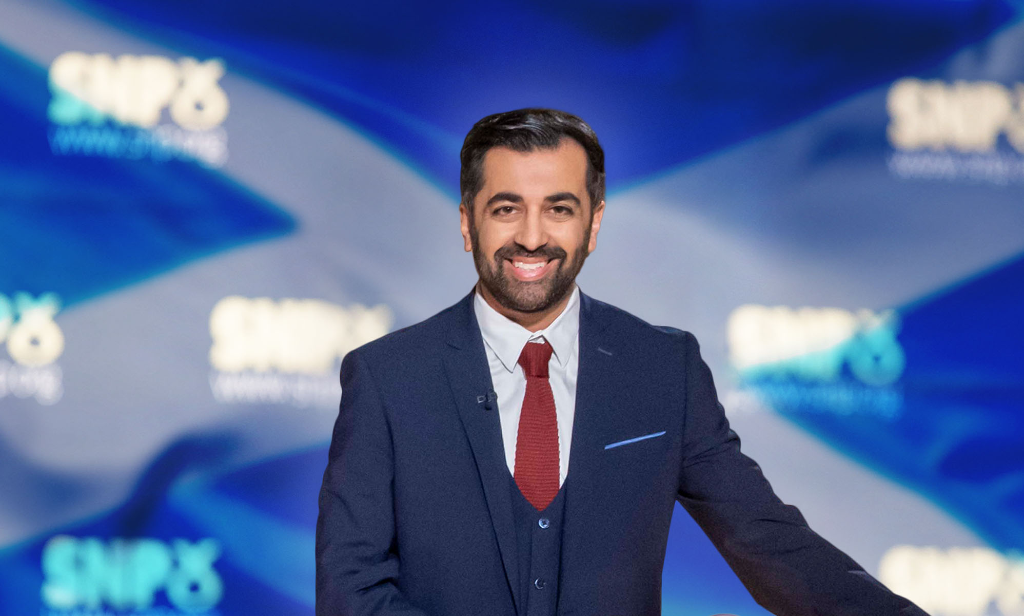 Humza Yousaf in front of an SNP banner