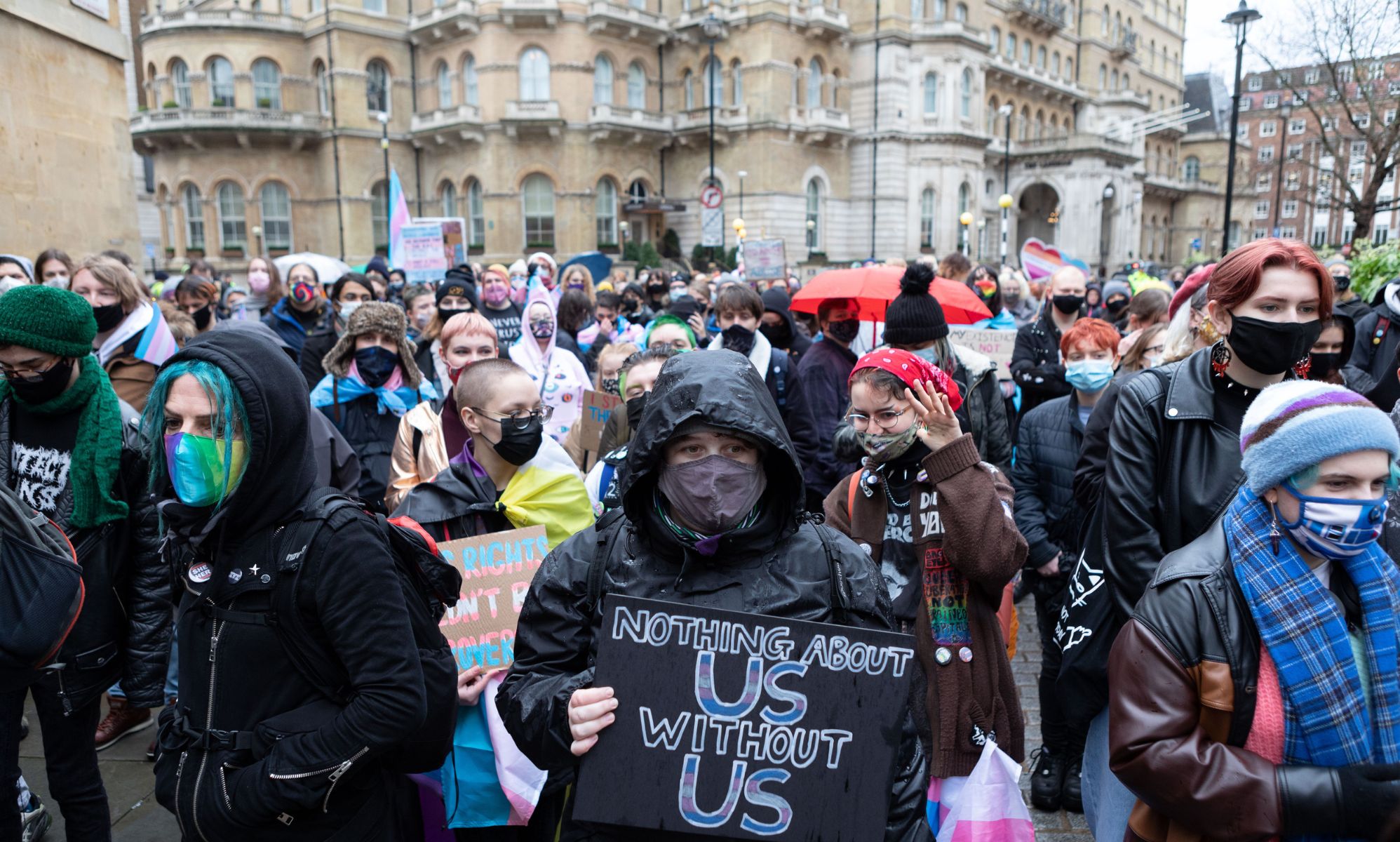 Demonstrator holds placard reading &quot;Nothing about us without us&quot; during protest outside BBC office over anti-trans article