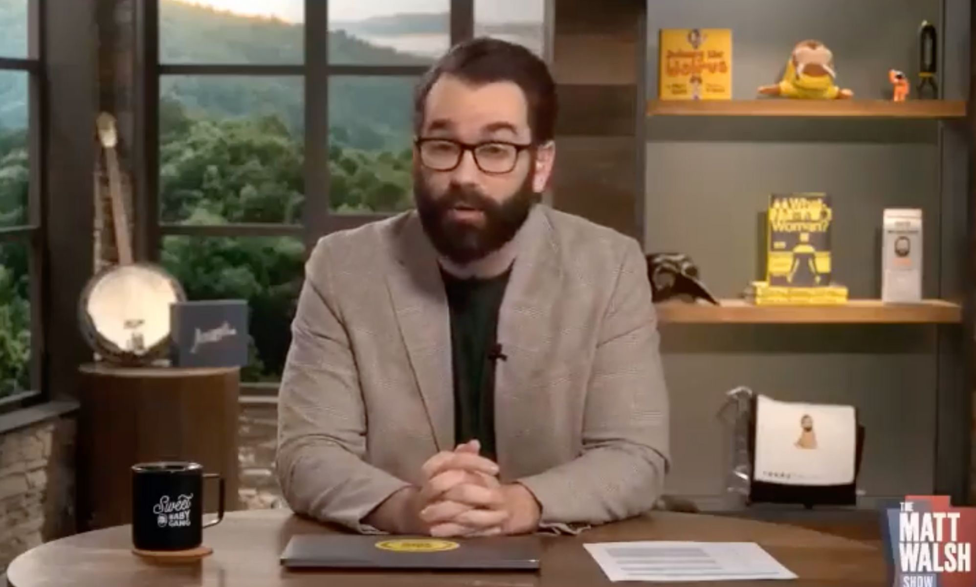 The Daily Wire host Matt Walsh wears a black shirt and brown jacket as he states that he would &quot;rather be dead&quot; than have a trans child on his show