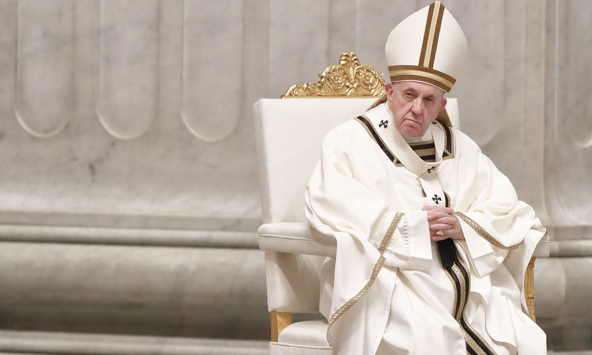 Pope Francis wears a white garments as he leads a mass in the Vatican