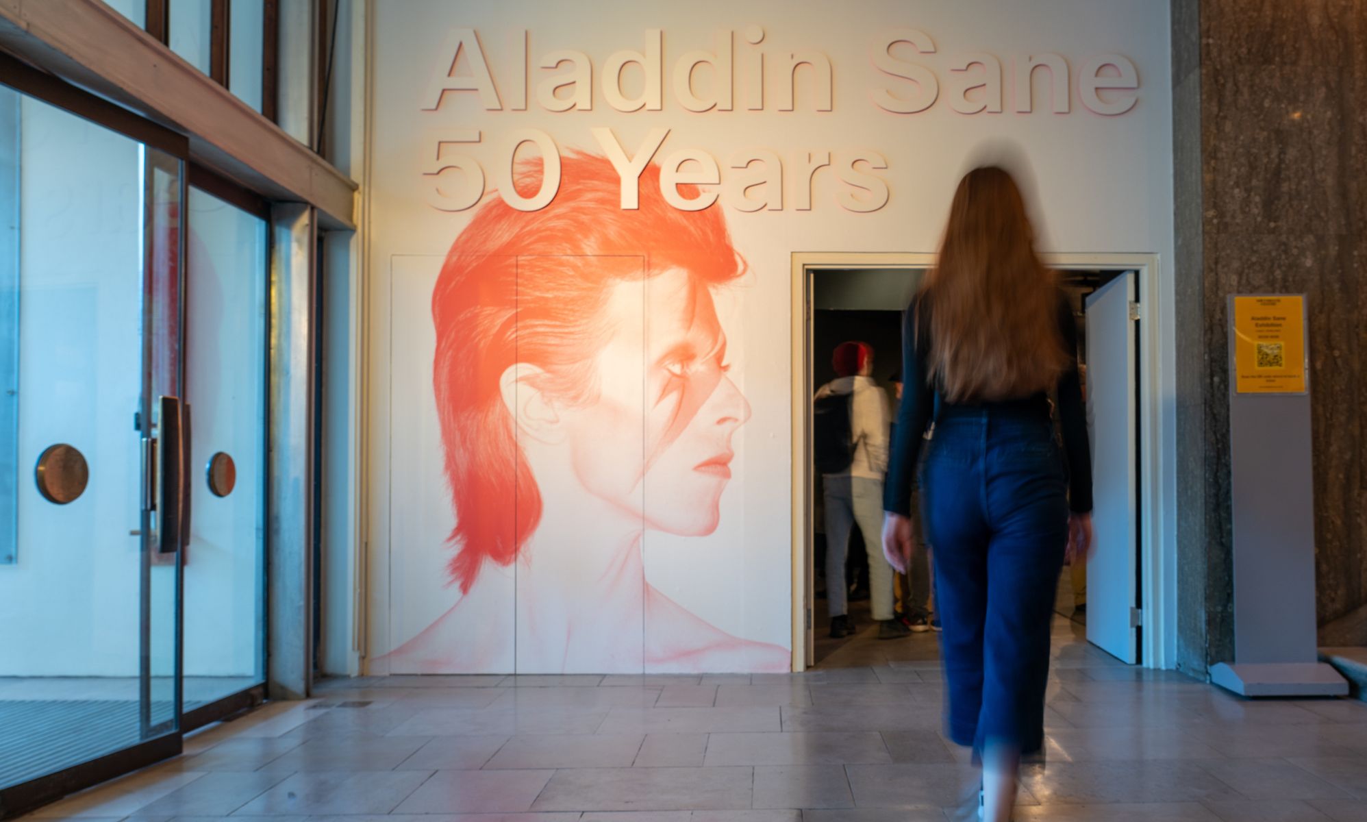 David Bowie in signature Aladdin Sane make-up on the wall at London