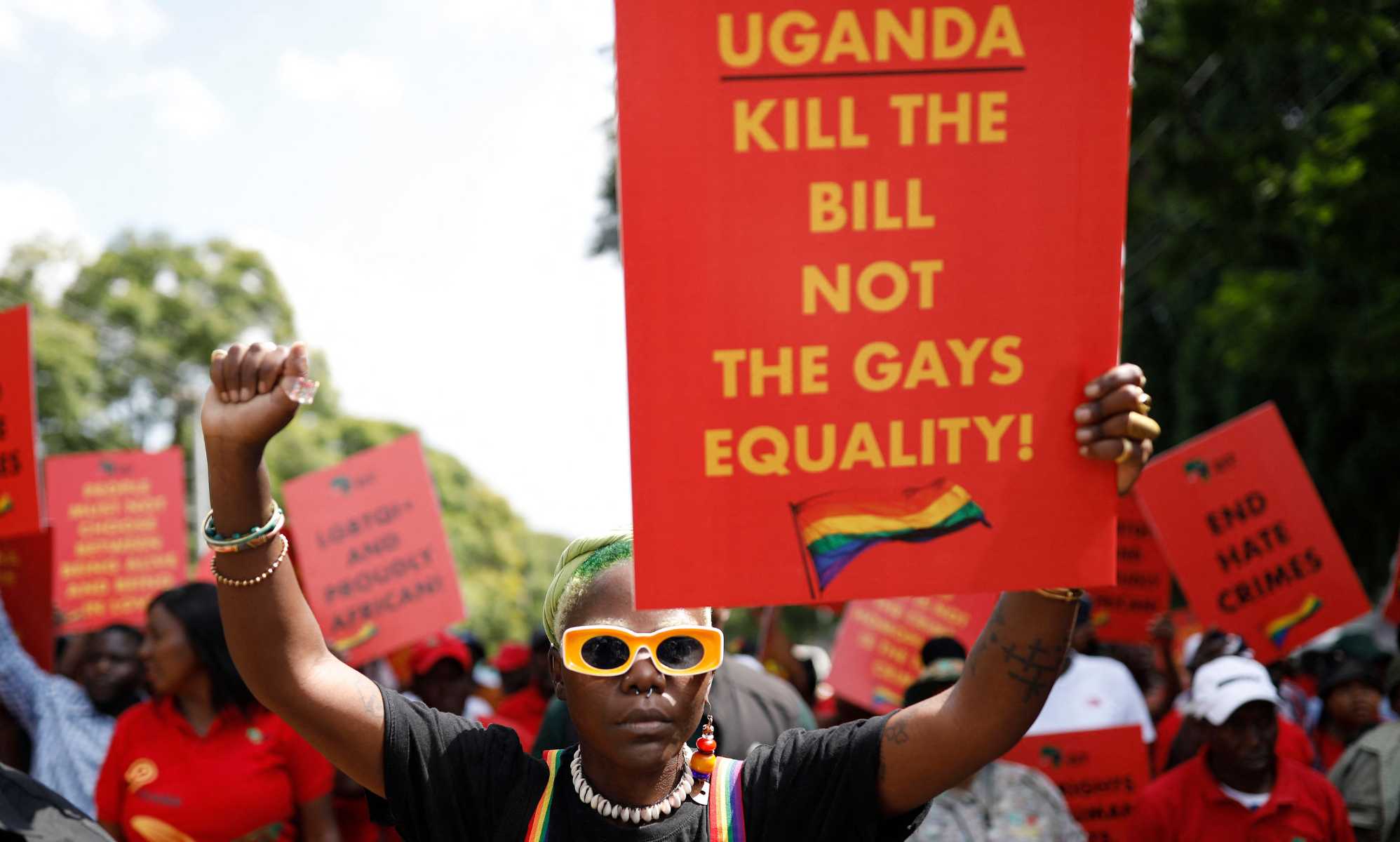 DeLovie Kwagala pictured holding a sign that says &quot;Uganda Kill the bill not the gays equality!&quot;.