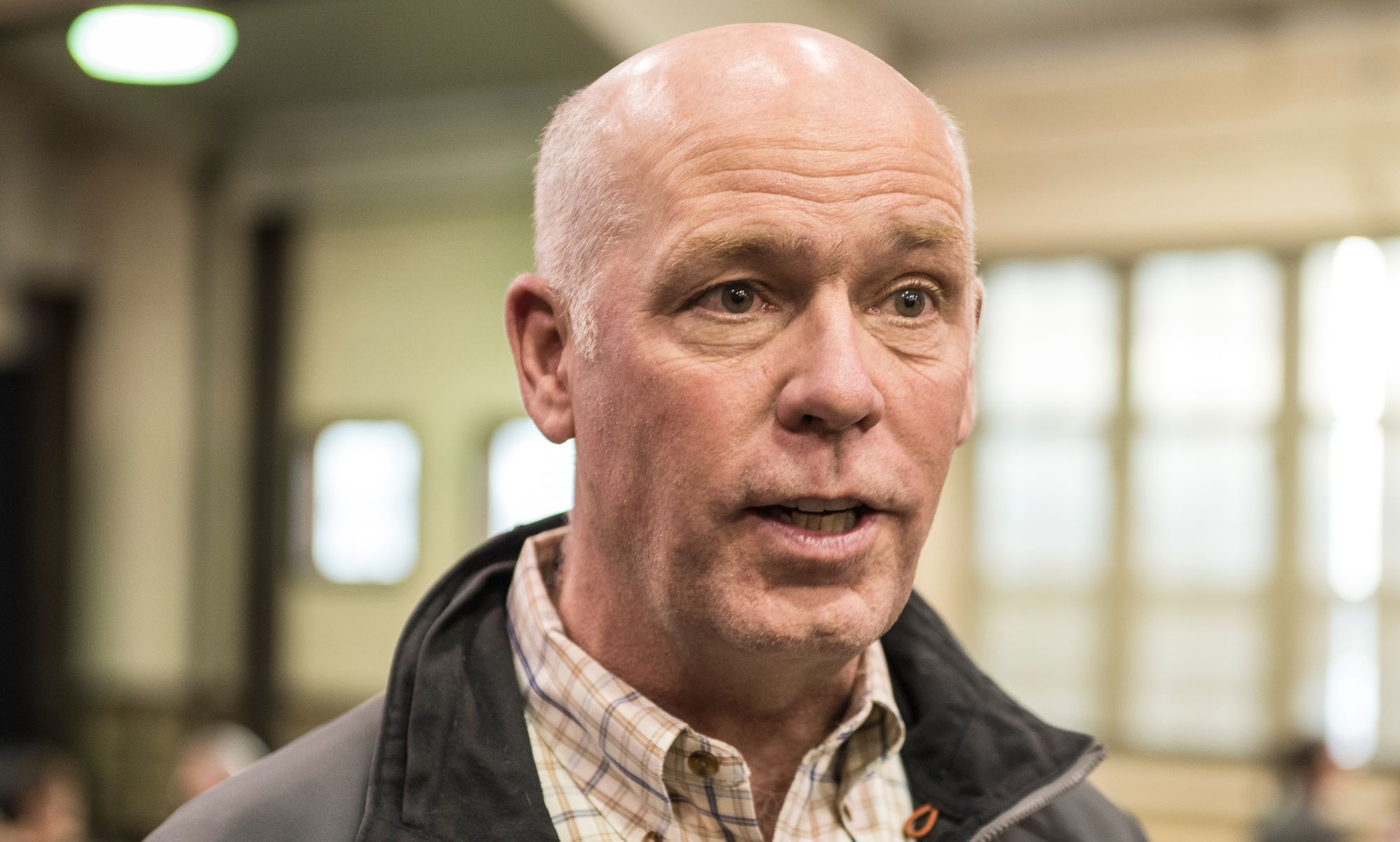 Montana Governor Greg Gianforte speaking in a warehouse.