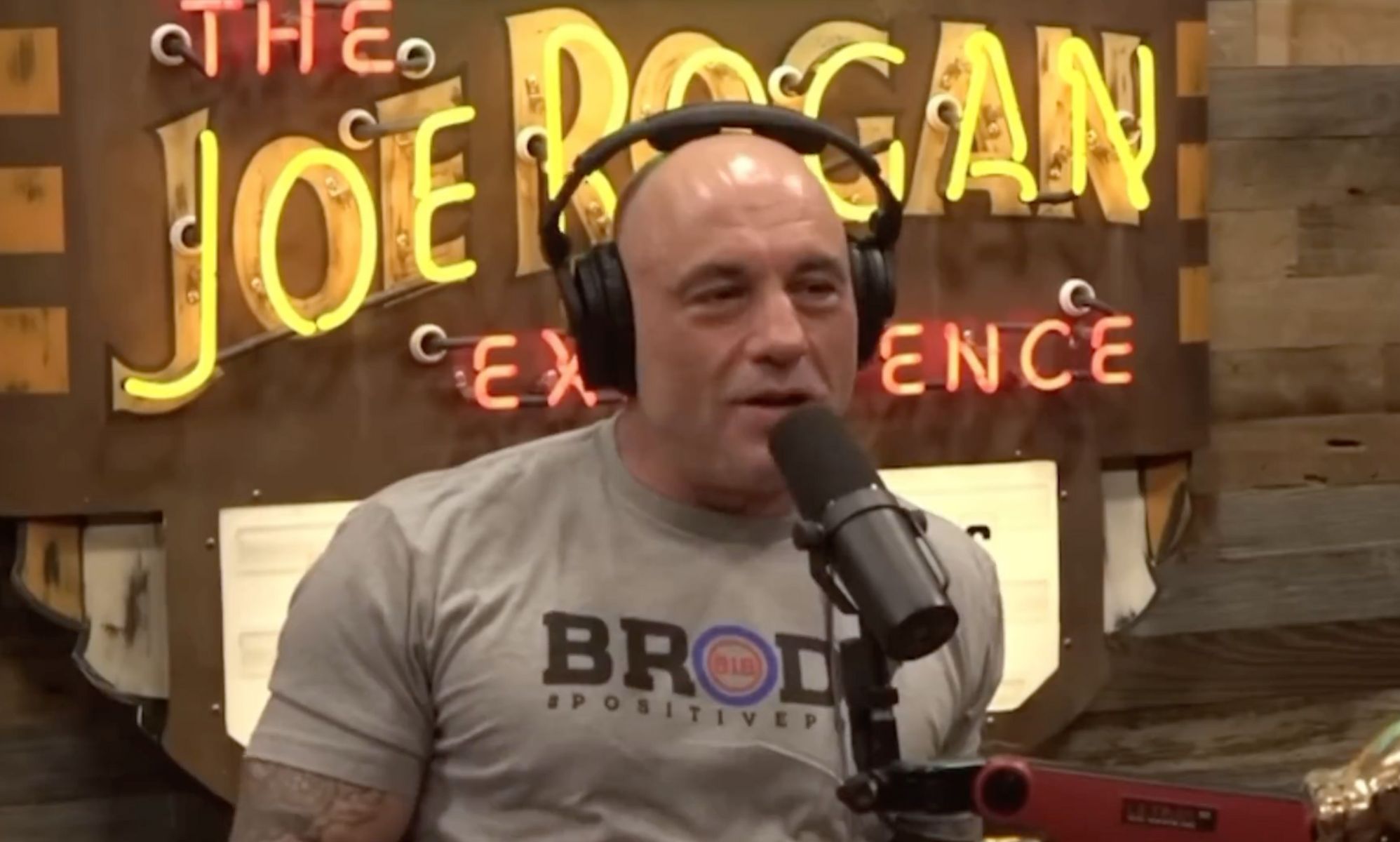 Controversial podcaster Joe Rogan wears a grey t-shirt as he discusses the controversy over trans influencer Dylan Mulvaney