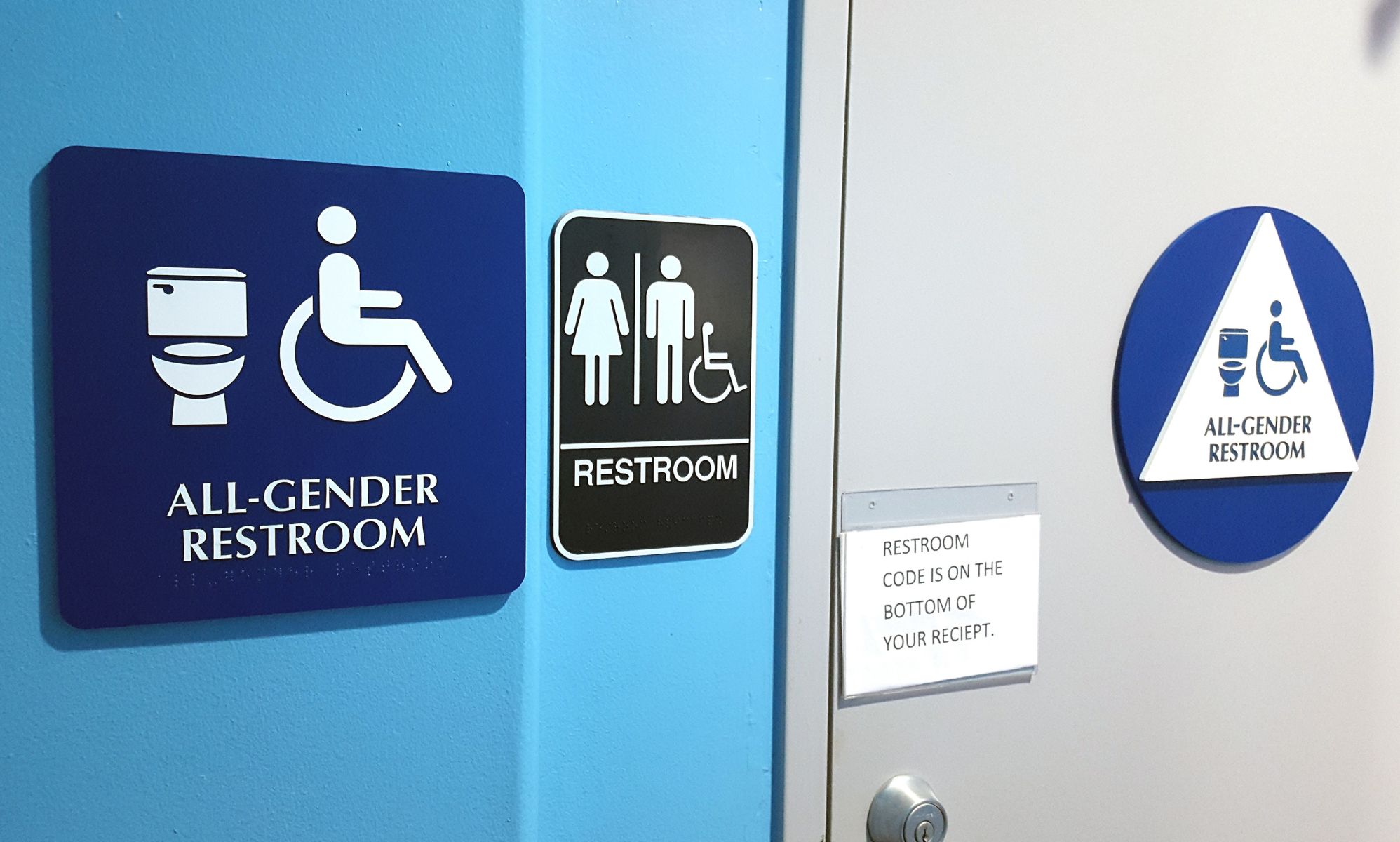 A set of sigjns indicating a gender-neutral bathroom facility.