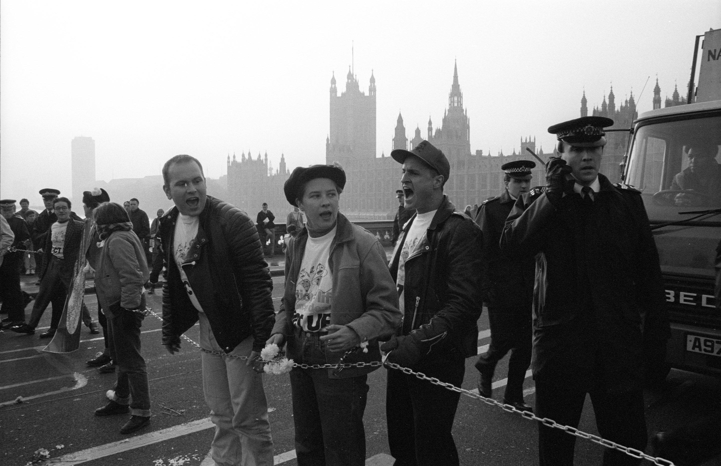 Paul Burston, third on the right of three activists, taking part in an ACT UP protest.