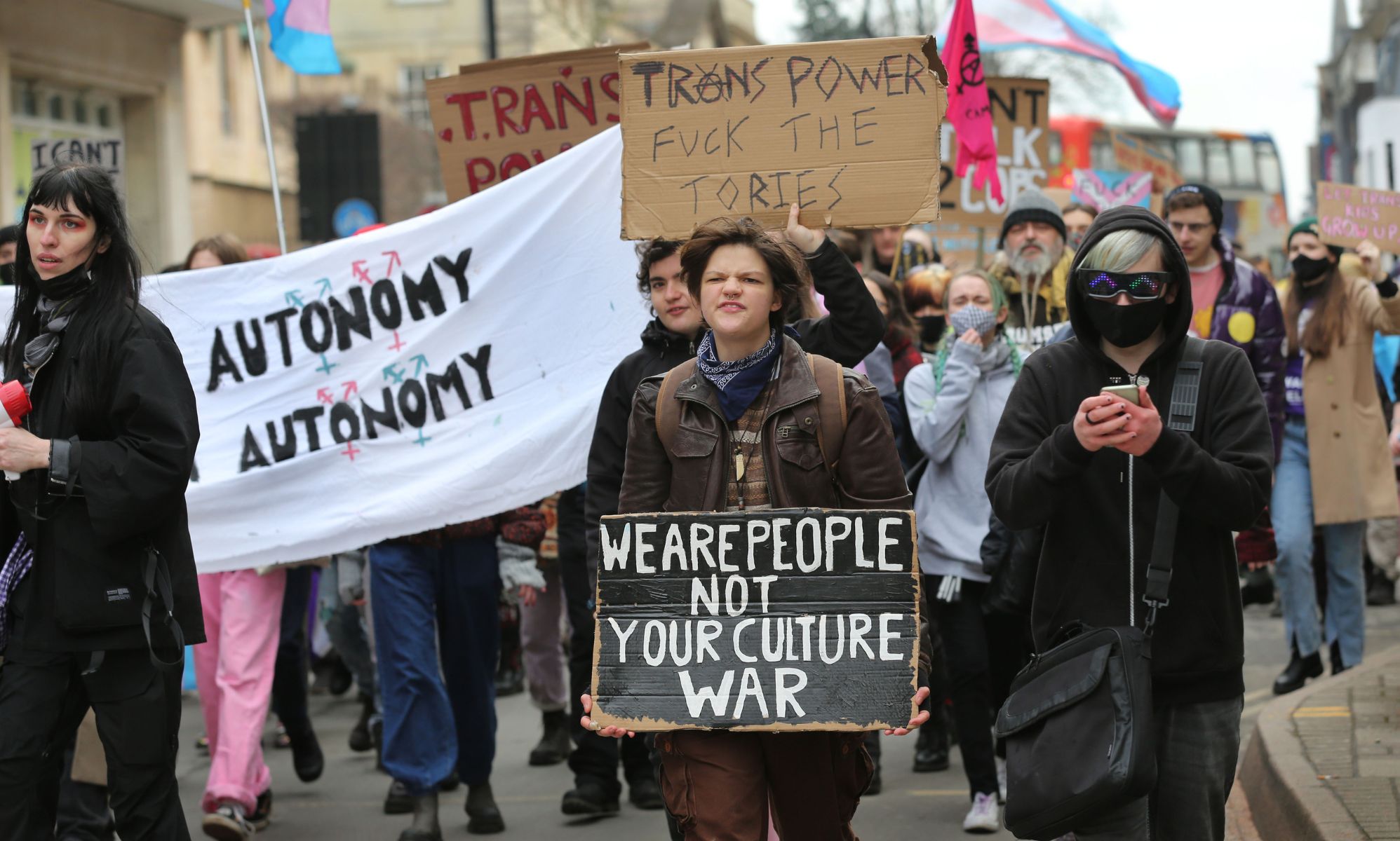A person holds up a sign reading 