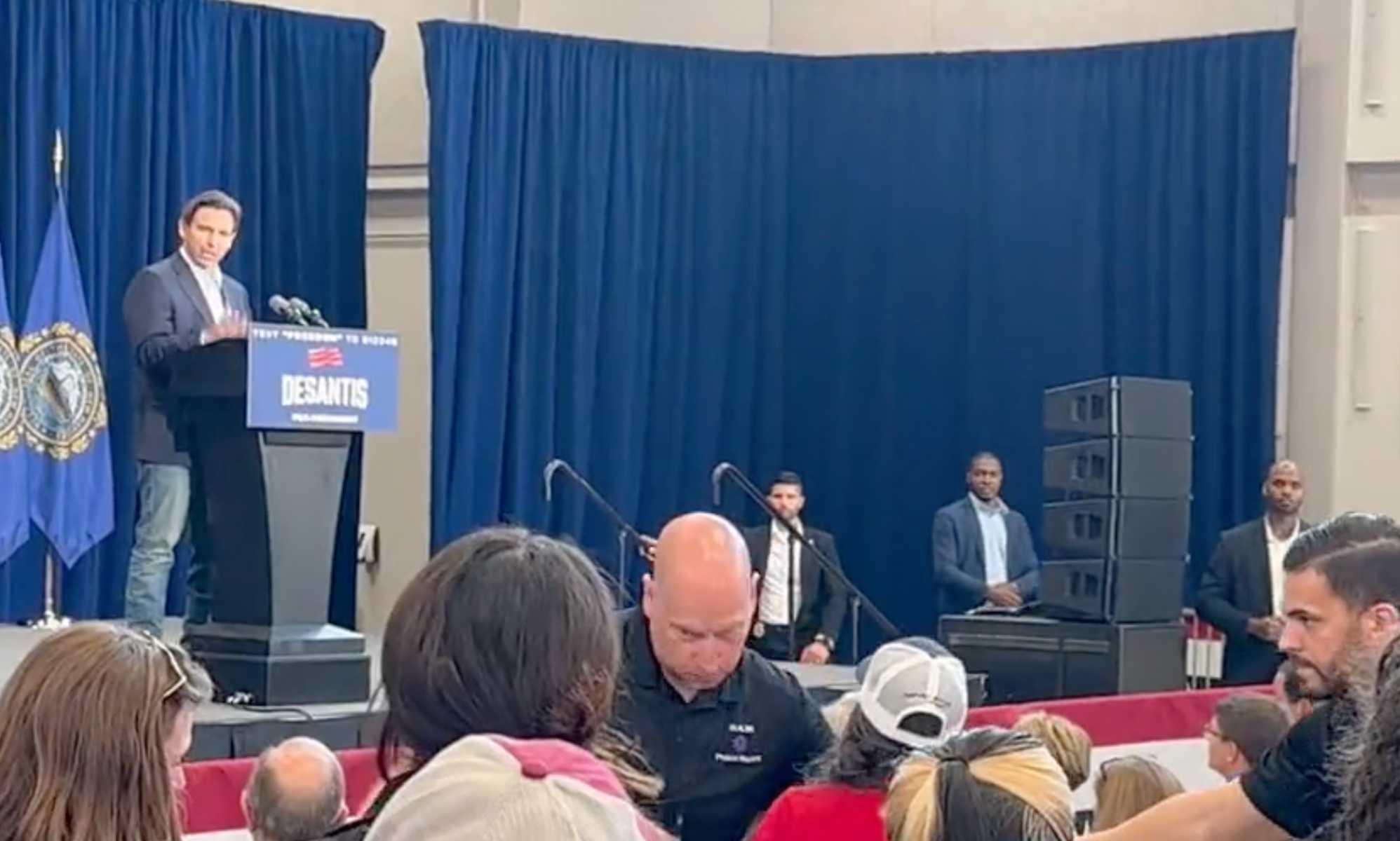 Ron DeSantis confronted by woman claiming murder cover-up at campaign event
