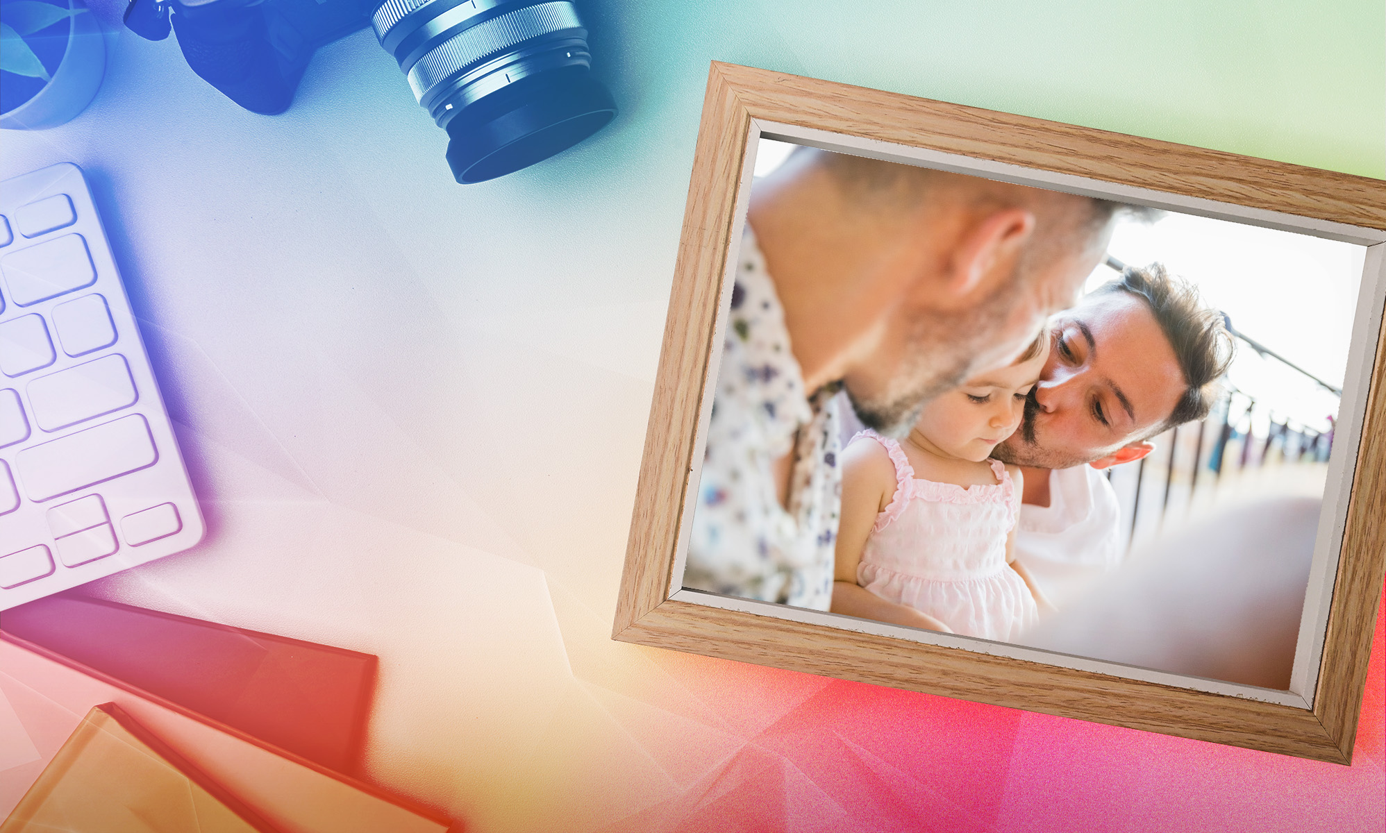 This is an image of a same sex couple and their child in a picture frame. The frame is sitting on a background of a desk. 