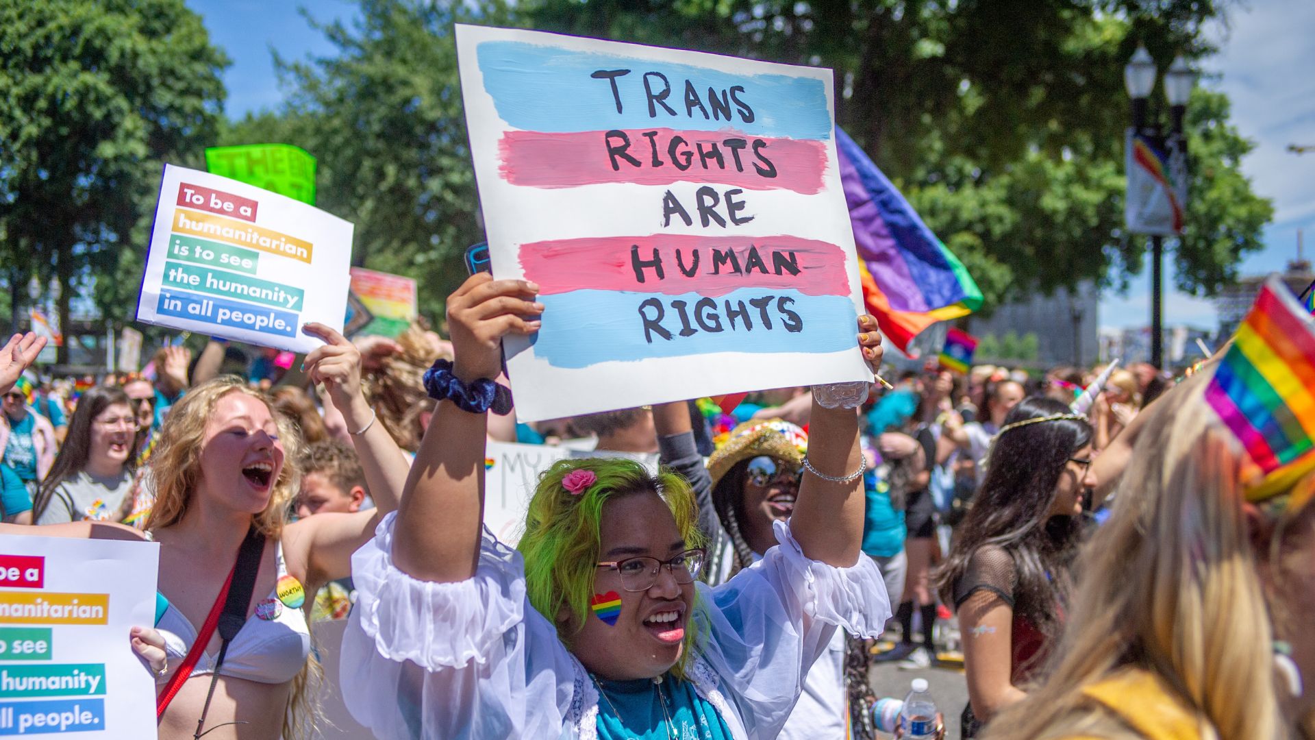 A person holds up a sign reading &quot;trans rights are human rights&quot; at a Pride parade in Portland, Oregon in 2019