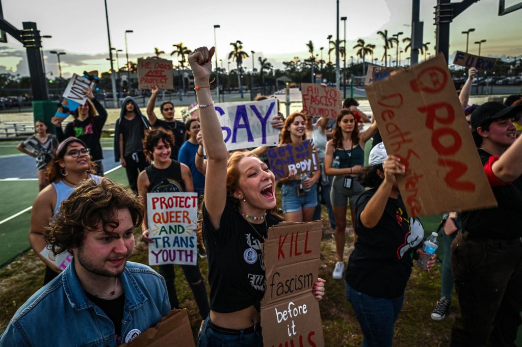 LGBTQ rights supporters protest against Florida Governor Ron Desantis outside a &quot;Don