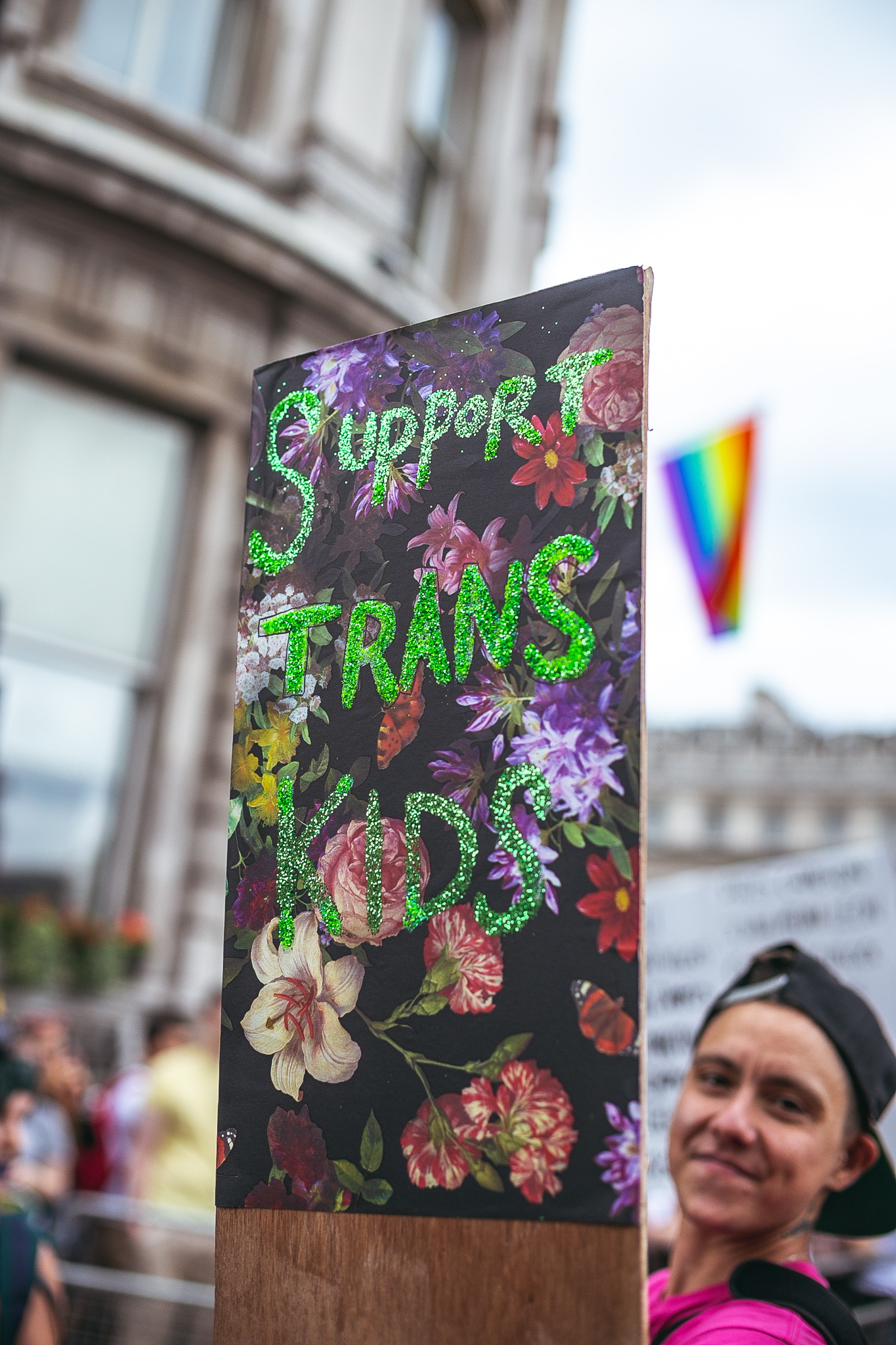 A person holds up a sign reading 