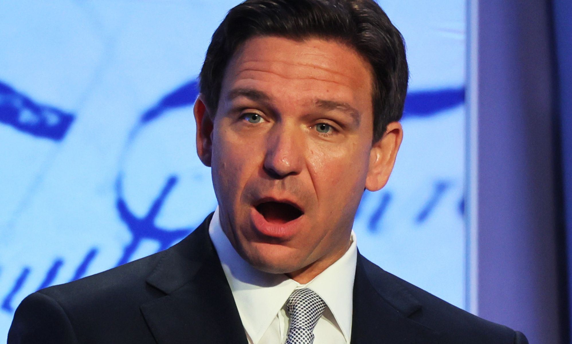 Ron DeSantis, mouth open, speaks during an event.