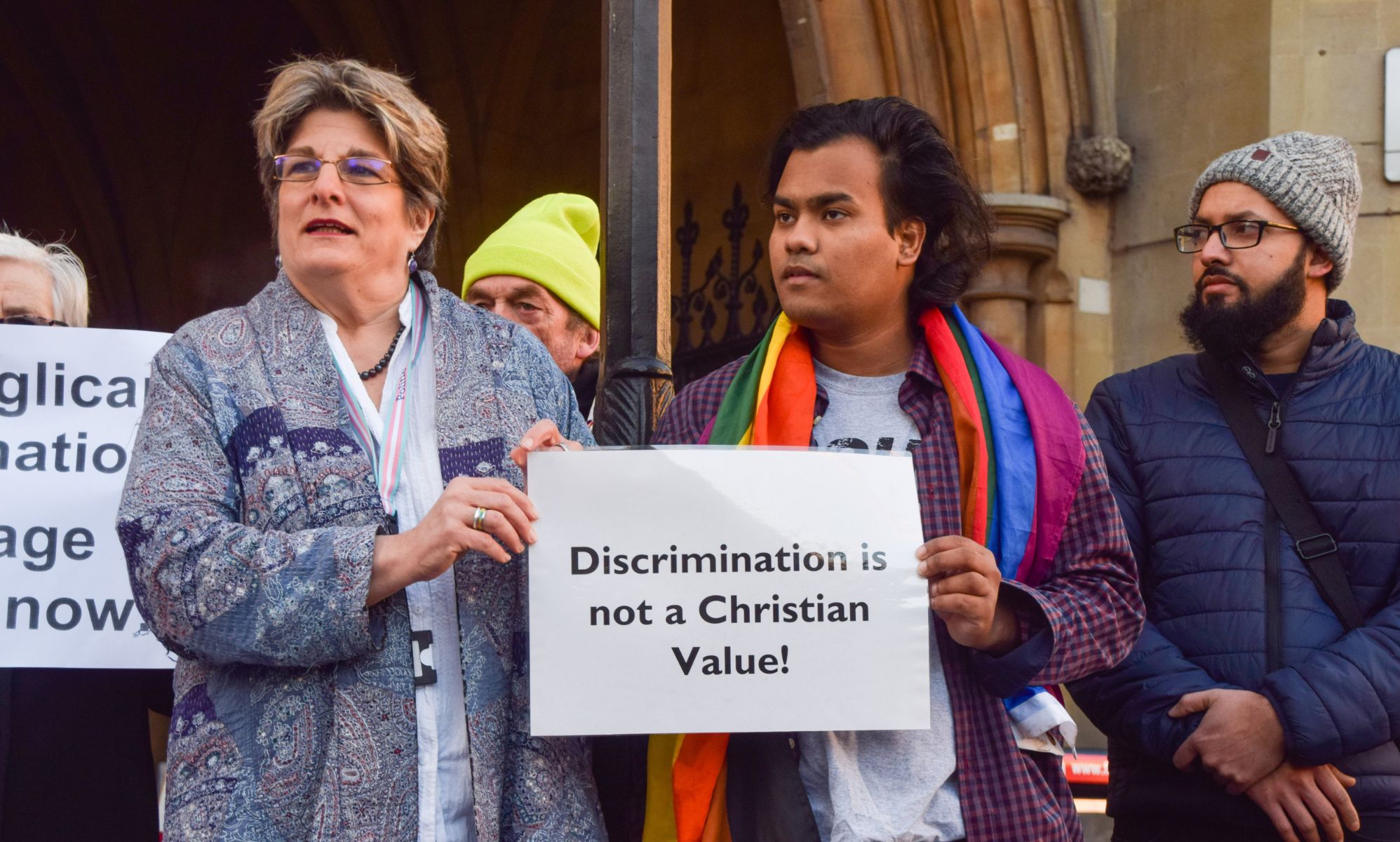 LGBTQ+ Christians hold up a sign reading &quot;discrimination is not a Christian value&quot; as they hold a protest outside a Church of England Synod meeting on blessings for same-sex couples