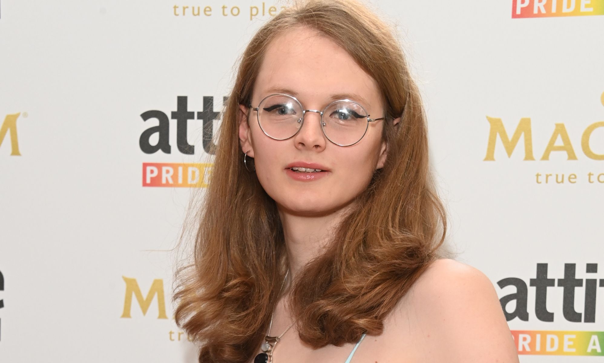 Emily Bridges photographed on a red carpet.