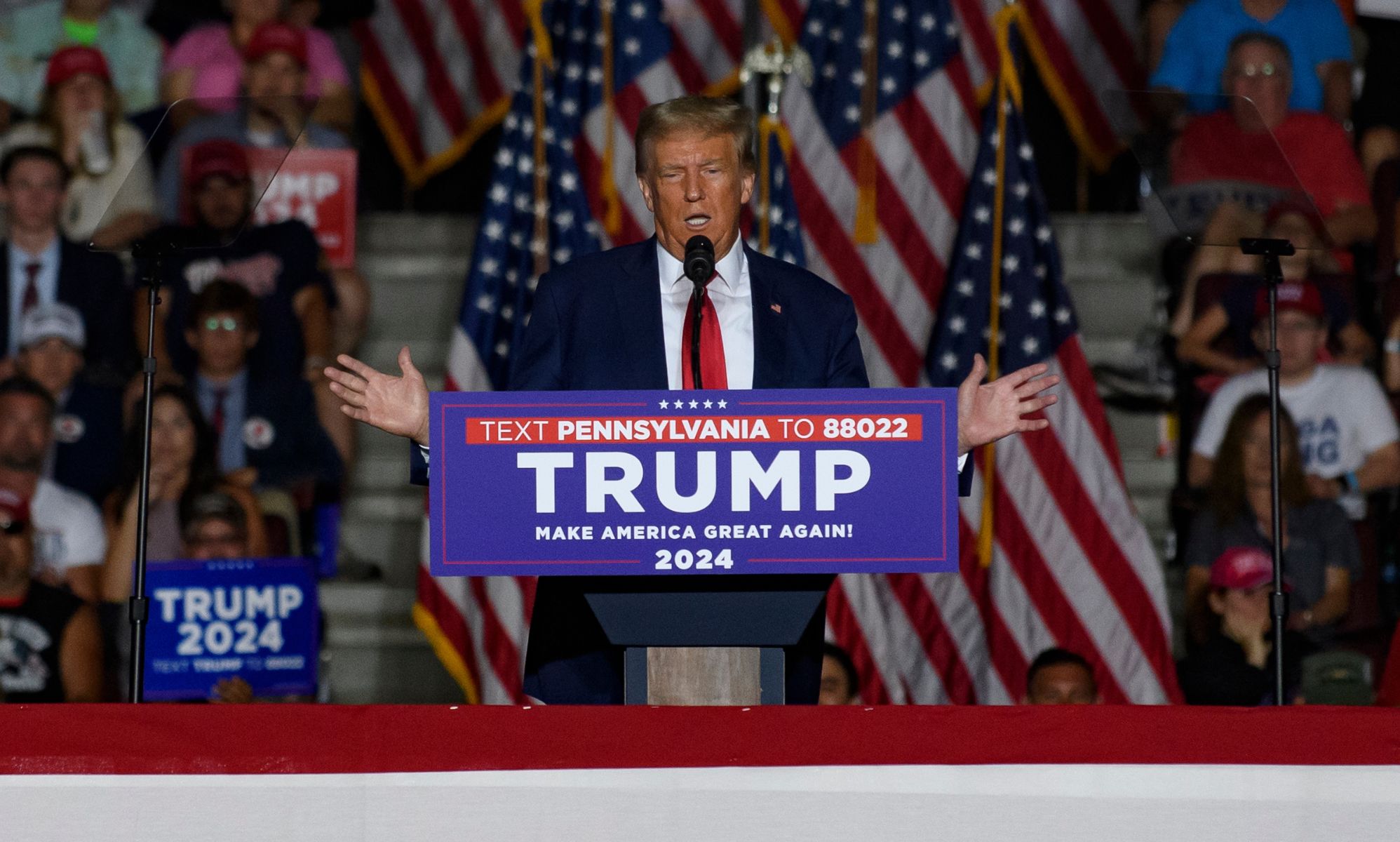 Donald Trump wears a white shirt, red tie and dark jacket as he speaks at a campaign event