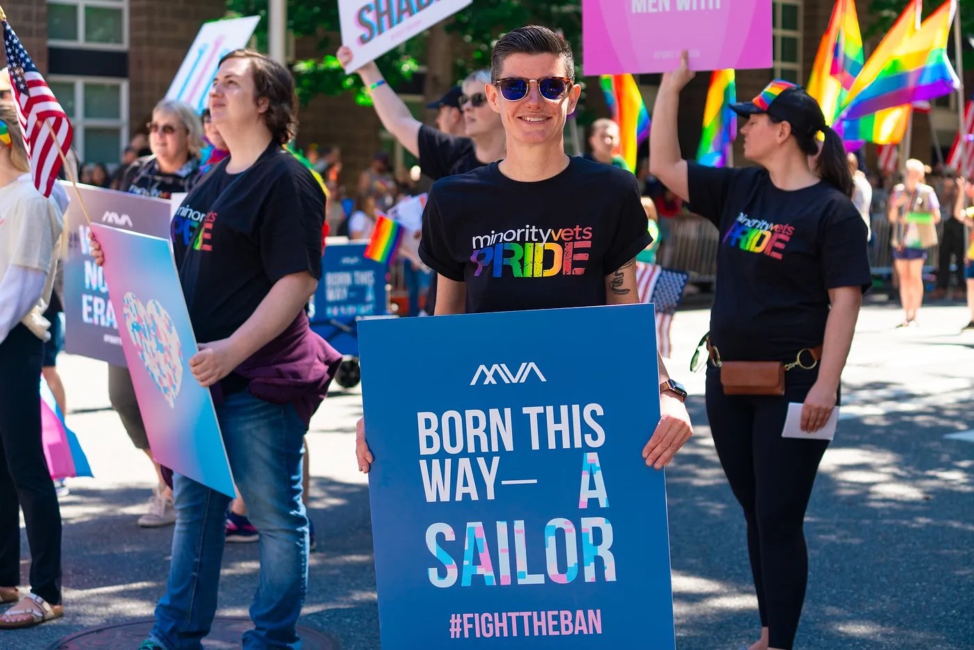 Non-binary Navy veteran and activist Lindsay Church holds up a sign reading 