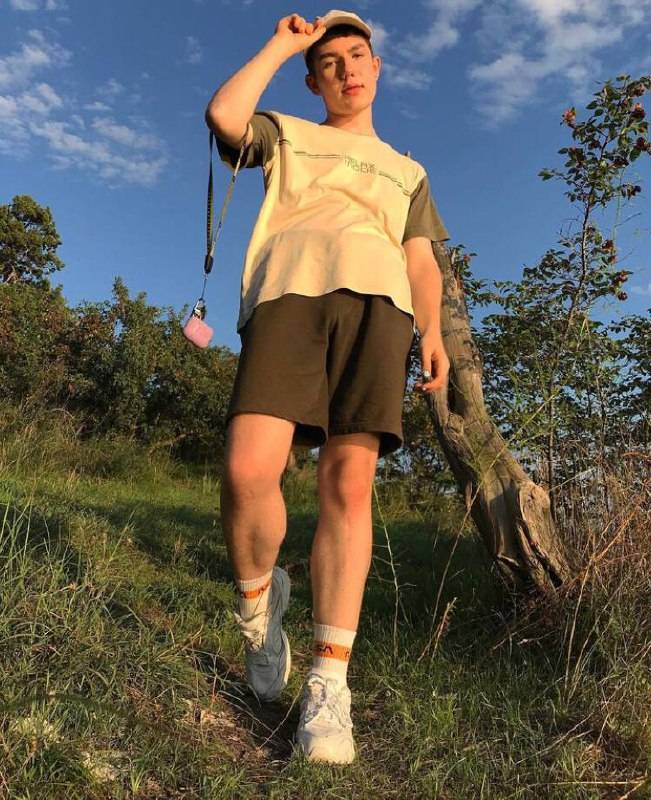 gay Russian university student, Max, poses as he walks outside