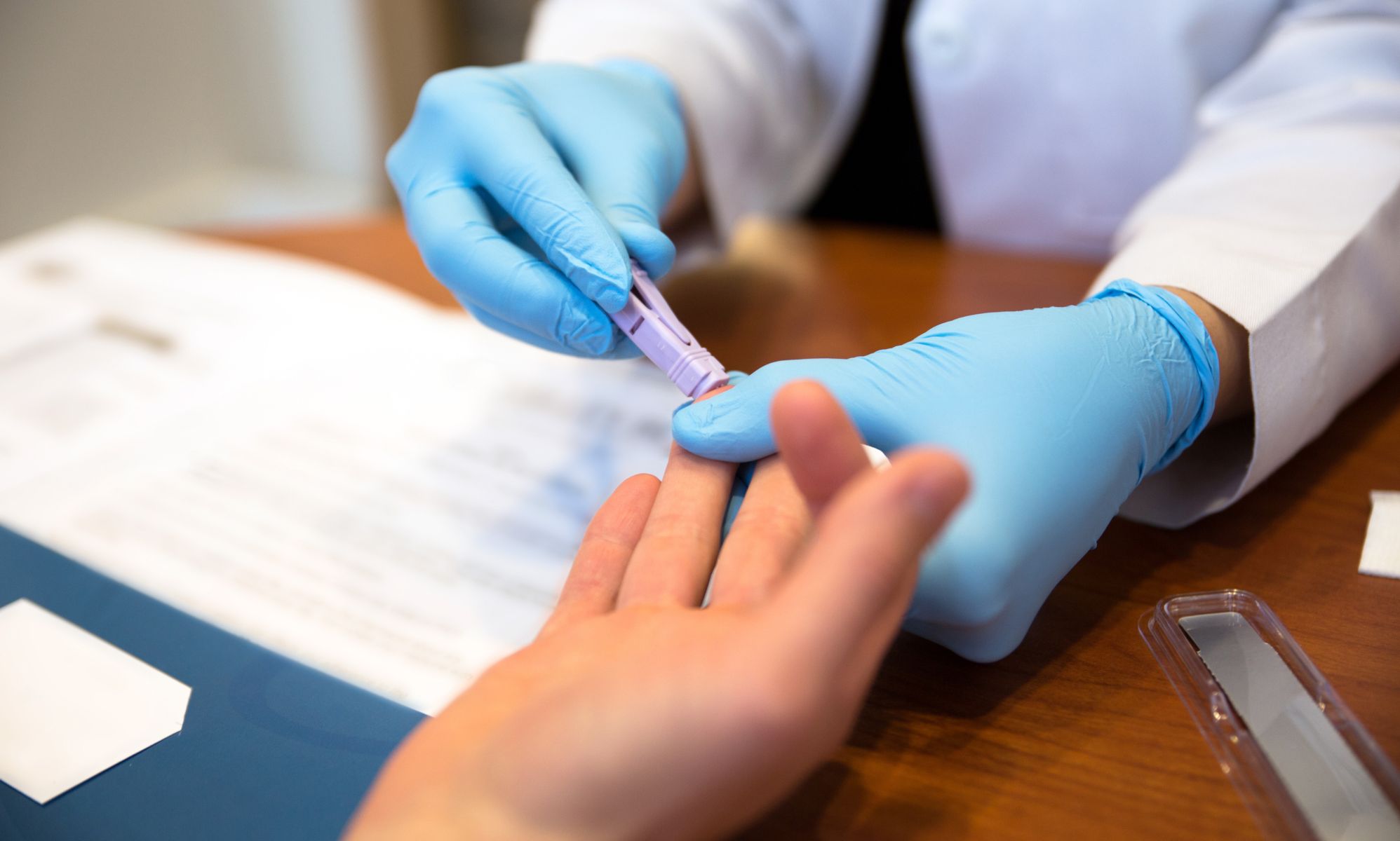 Person getting a finger-prick HIV test