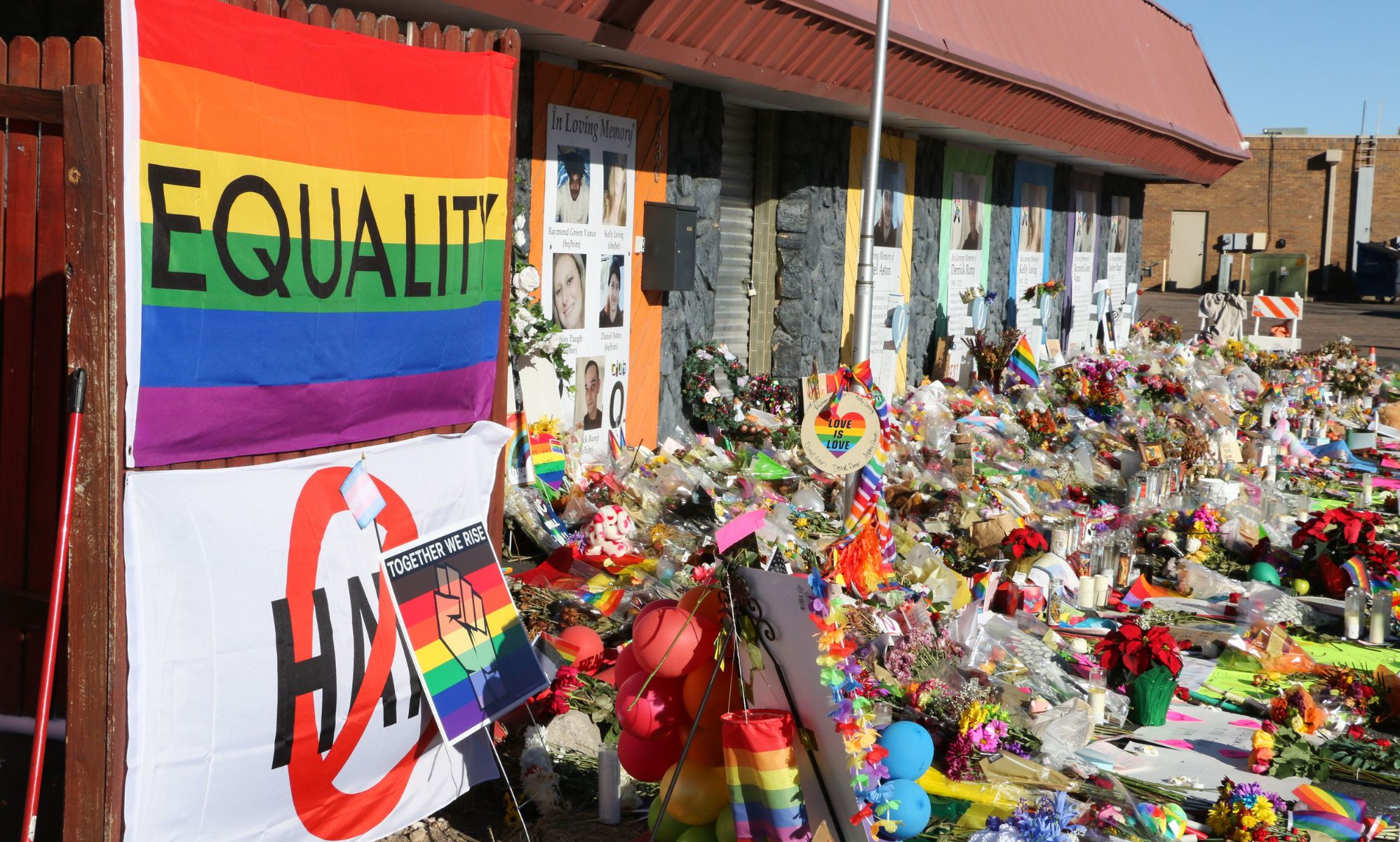 A pride flag reading &quot;Equality&quot; and hundreds of items adorn the closed entrance to Club Q. The Club Q shooting memorial continues growing one week after a mass shooter took five lives and injured 18 others on Nov. 19 at an LGBTQ club in Colorado Springs. 
