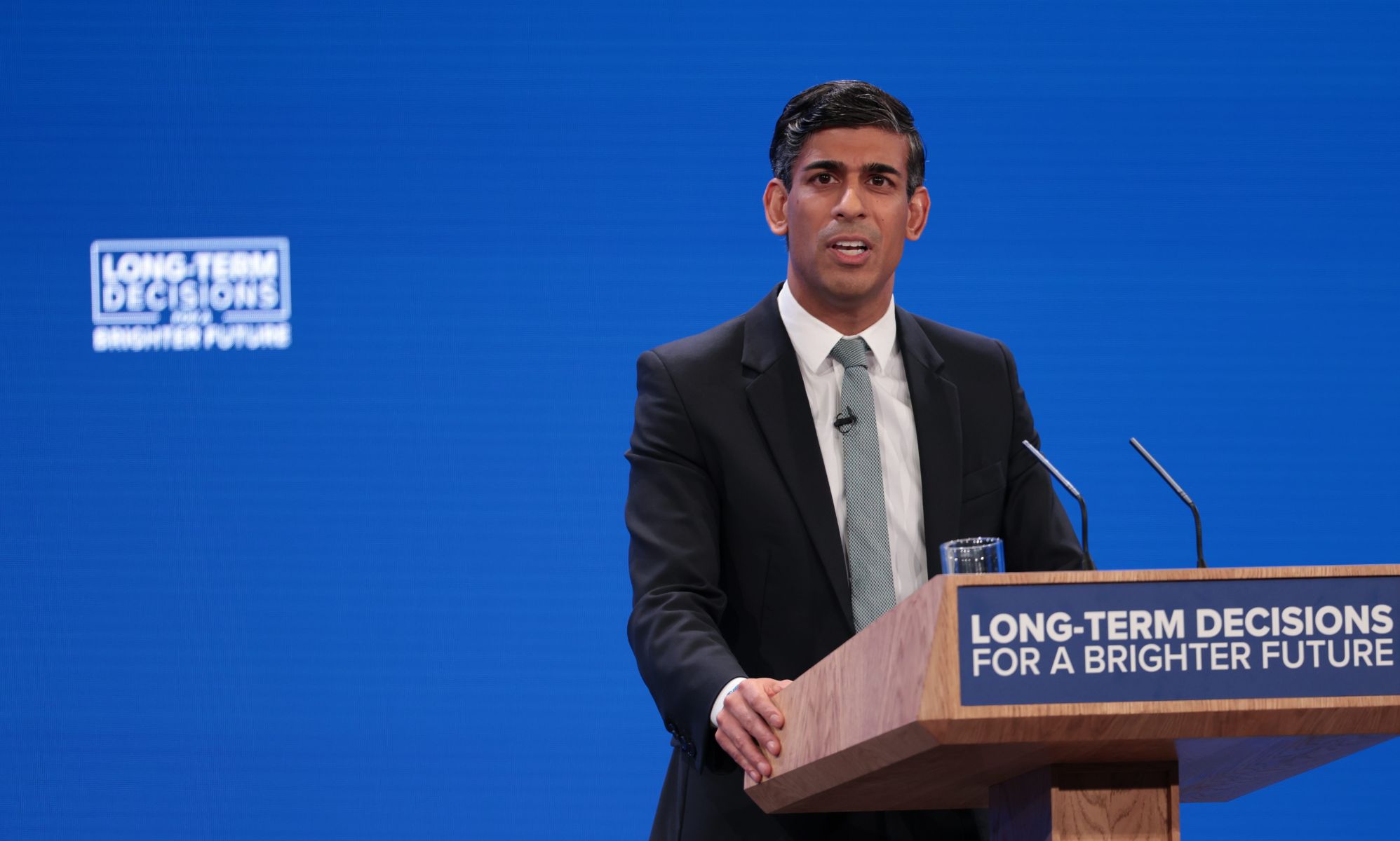 UK prime minister Rishi Sunak wears a suit and tie as he makes a speech at the Conservative Party conference. The prime minister and UK government have been criticised for making anti-trans remarks and failing to tackle LGBTQ+ hate crimes in the country