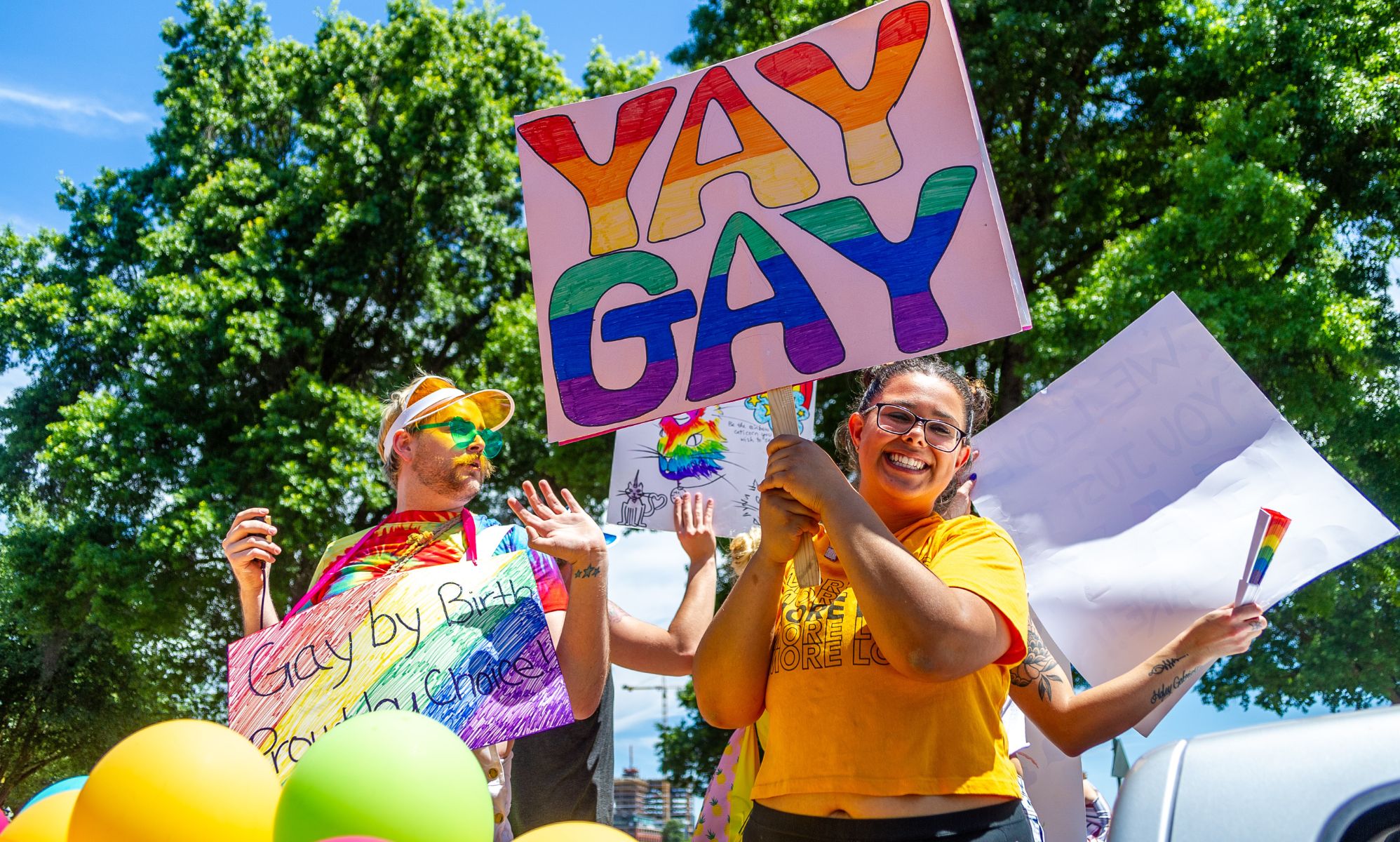 A person holds up a sign reading 