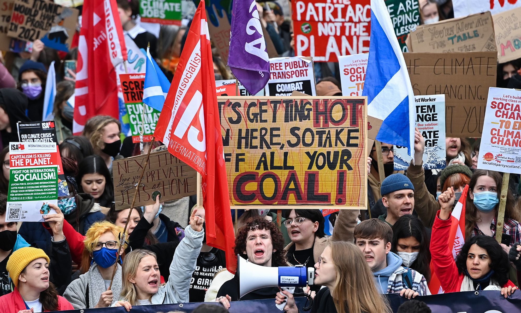 Climate protestors holding signs and flags