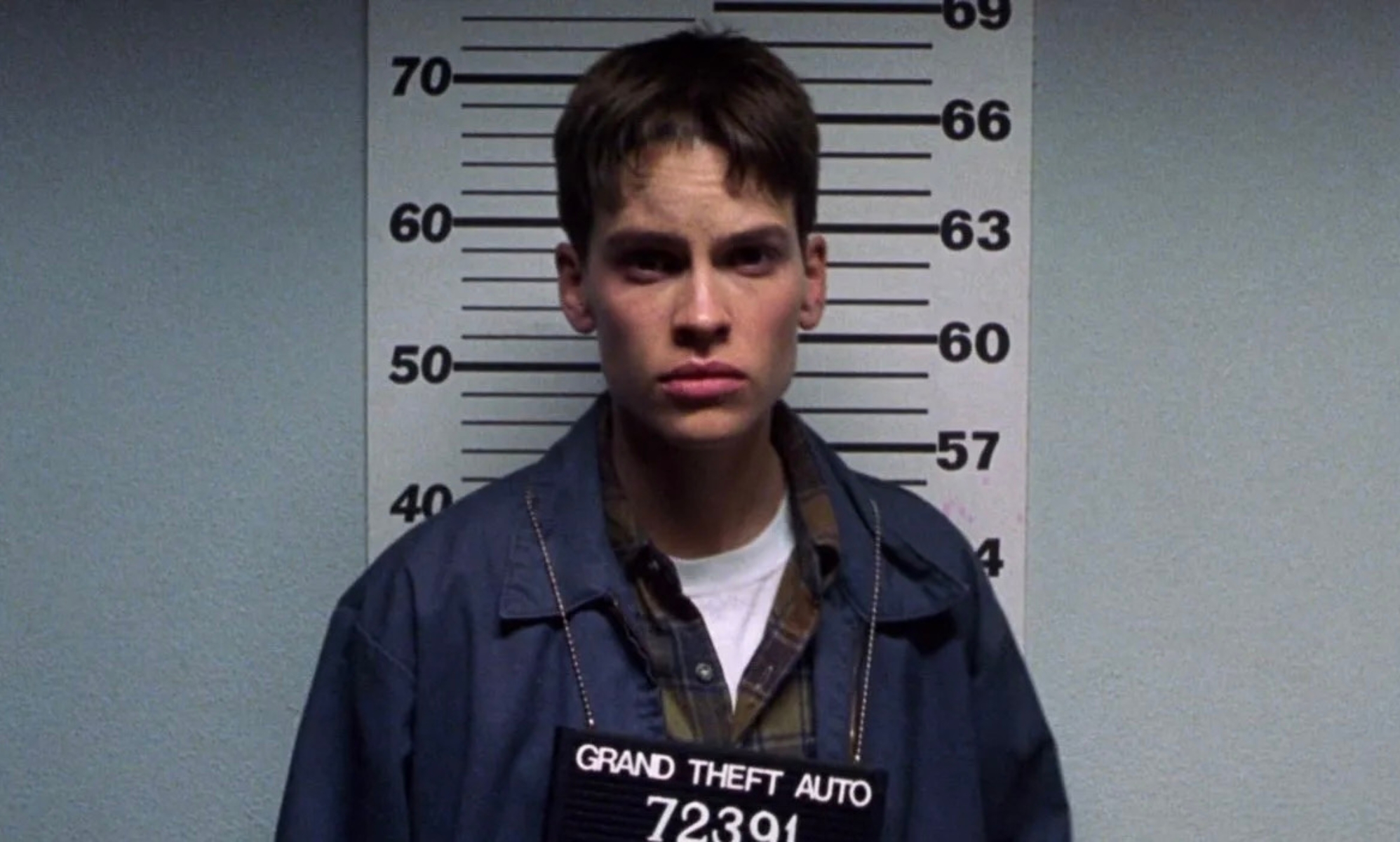 Hilary Swank as Brandon Teena getting a mugshot in Boys Don