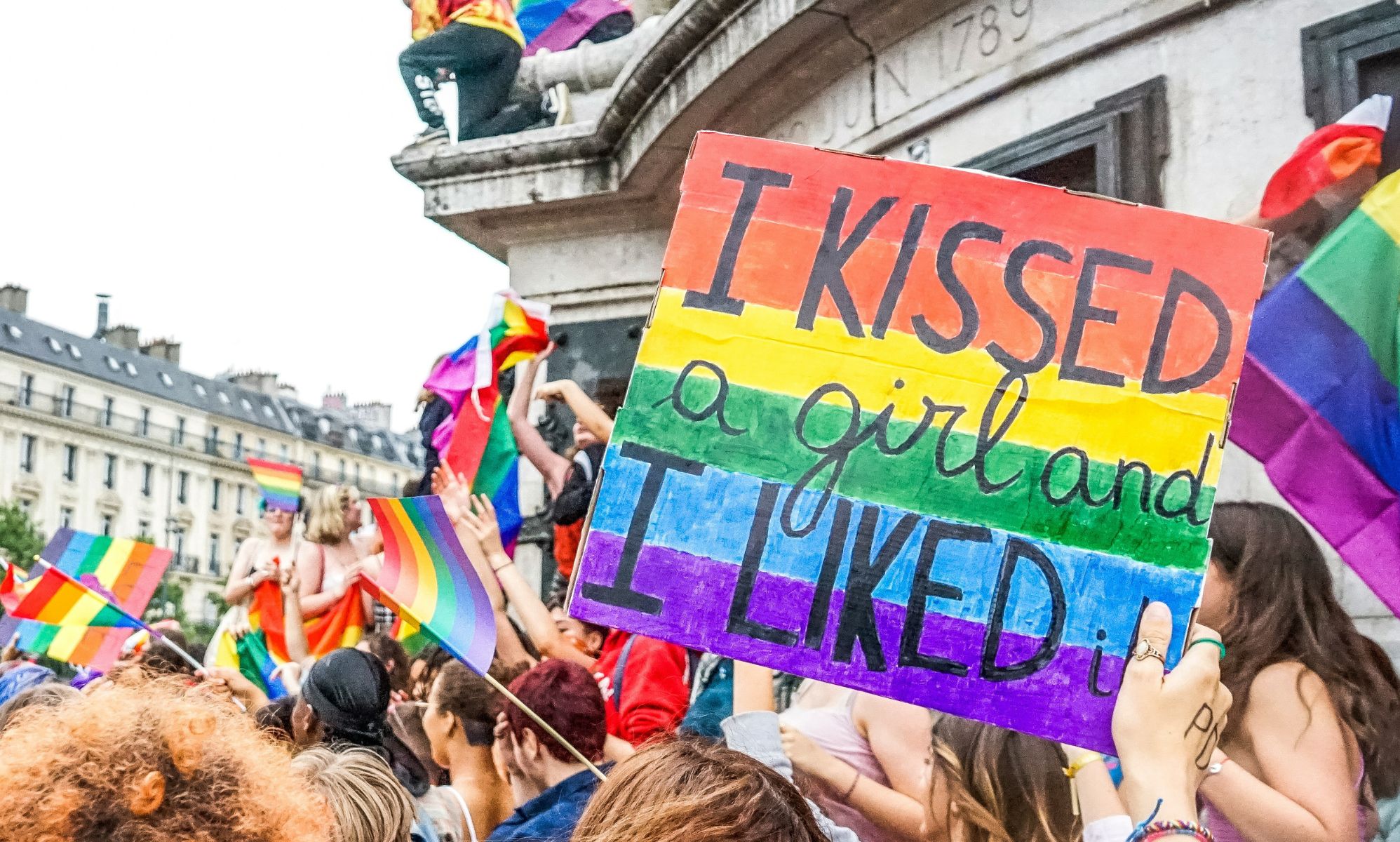 People at a protect with a poster held up high saying 