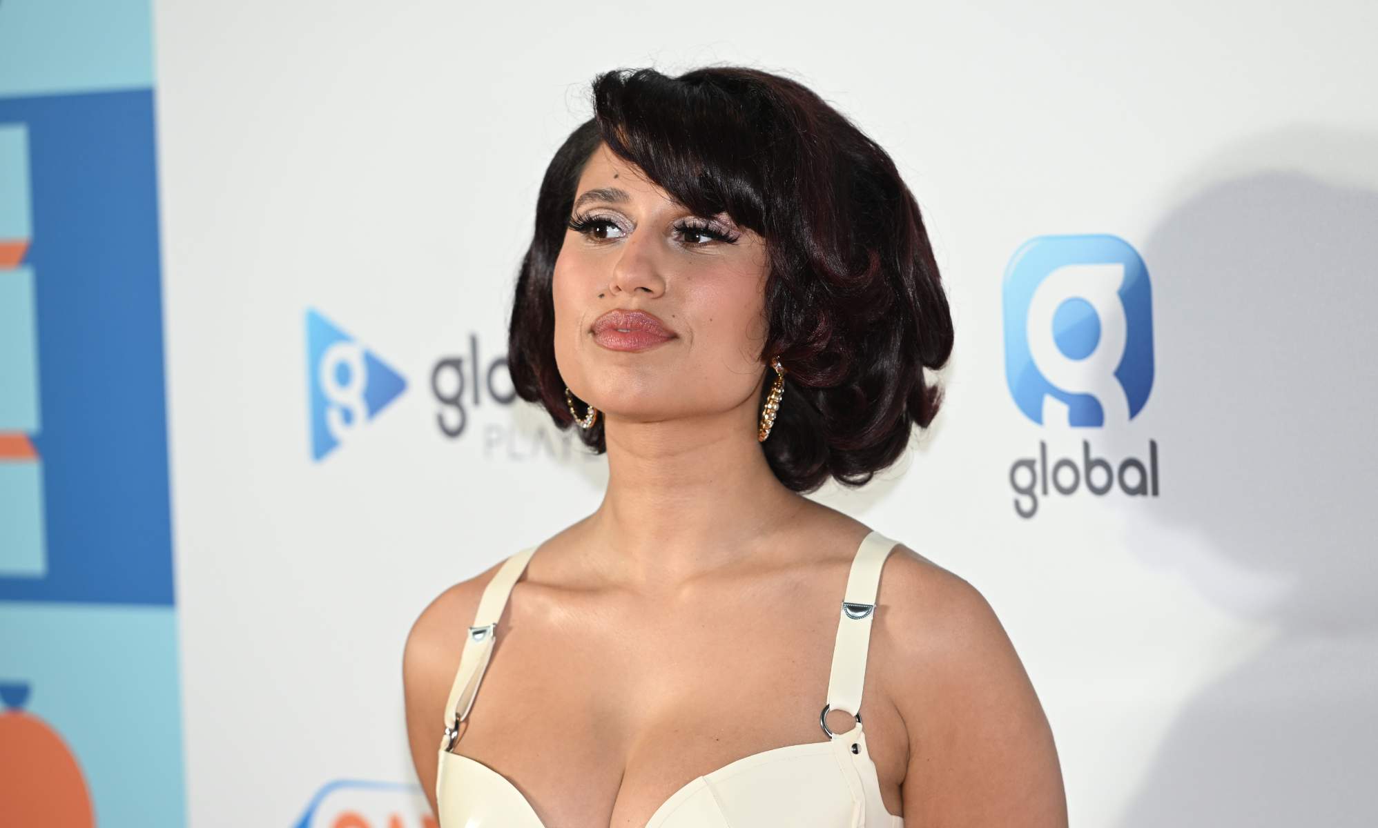 Raye poses on the red carpet at the Jingle Bell Ball.