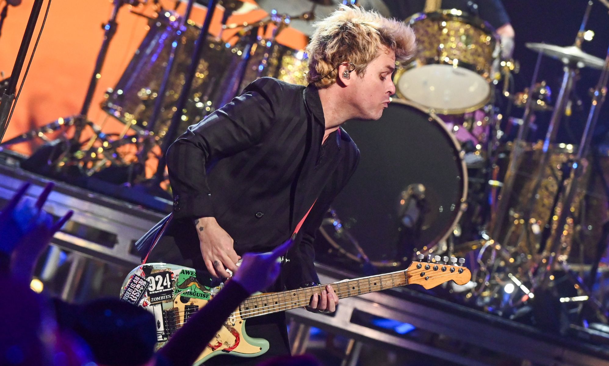 Green Day frontman Billie Joe Armstrong plays the guitar as the band performs onstage during a New Year