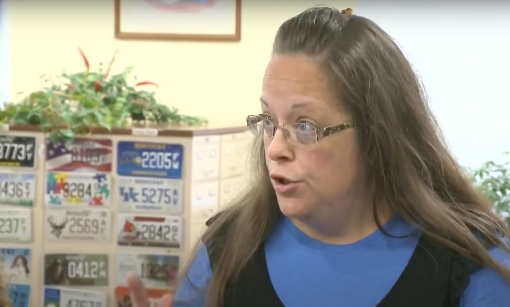Kim Davis, a former county clerk who refused to issue marriage licenses to same-sex couples in Kentucky, wears a blue outfit as she talks to someone off camera