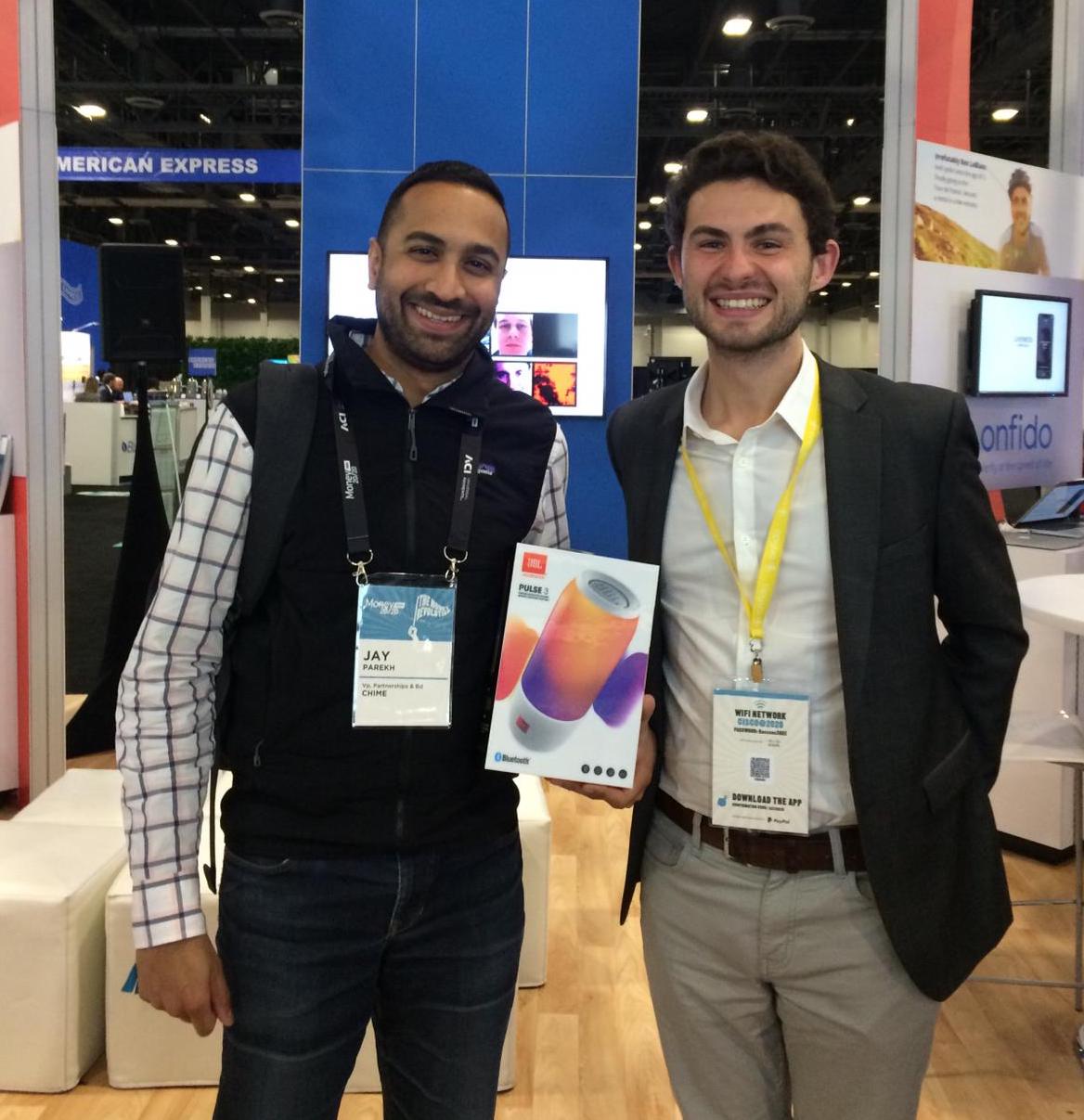 This is an image of two men standing in an exhibition hall. 