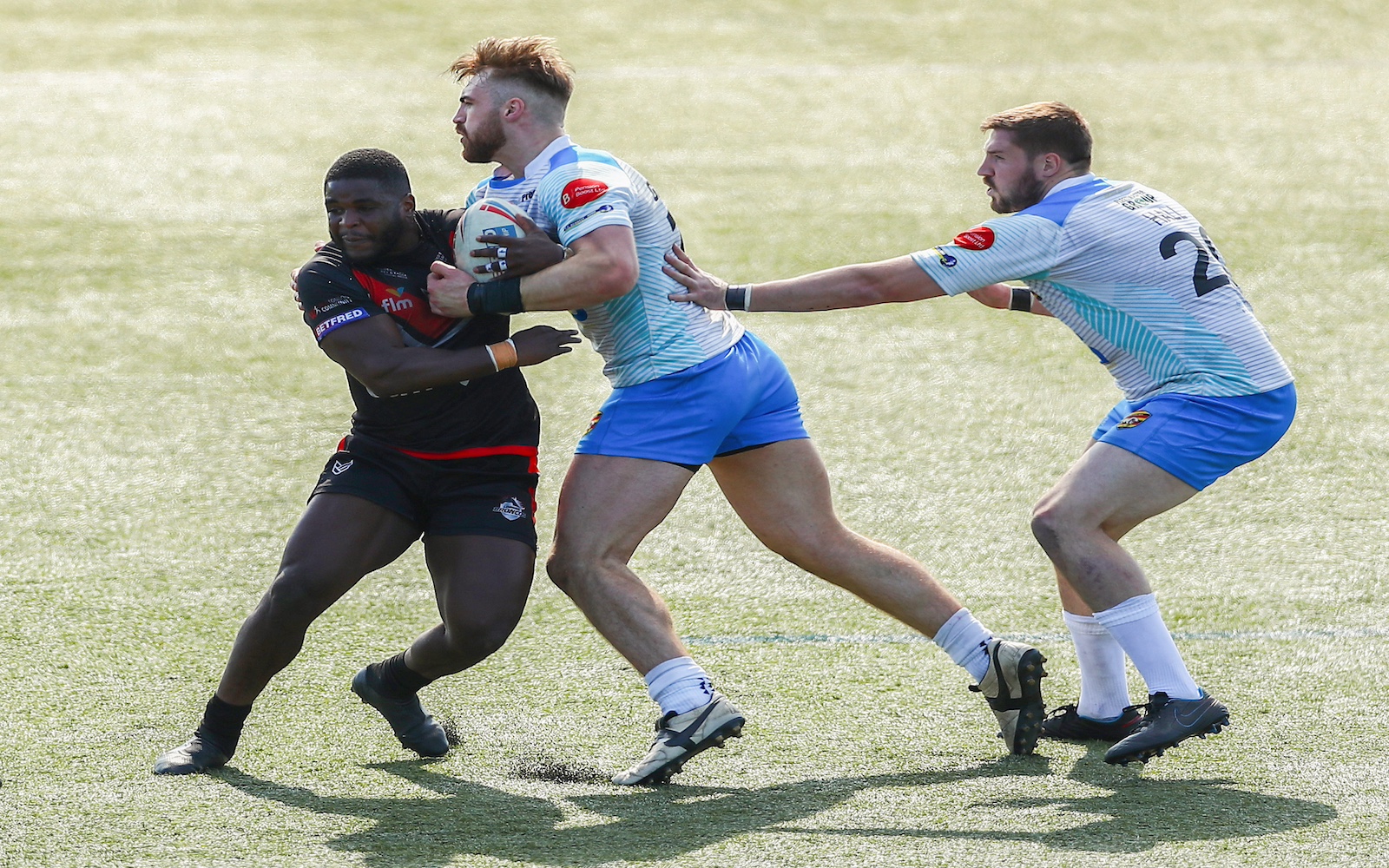 Tom Garratt (M) plays for Dewsbury Rams against London Broncos during the 2021 Betfred Championship (Photo by Jacques Feeney/Getty Images)