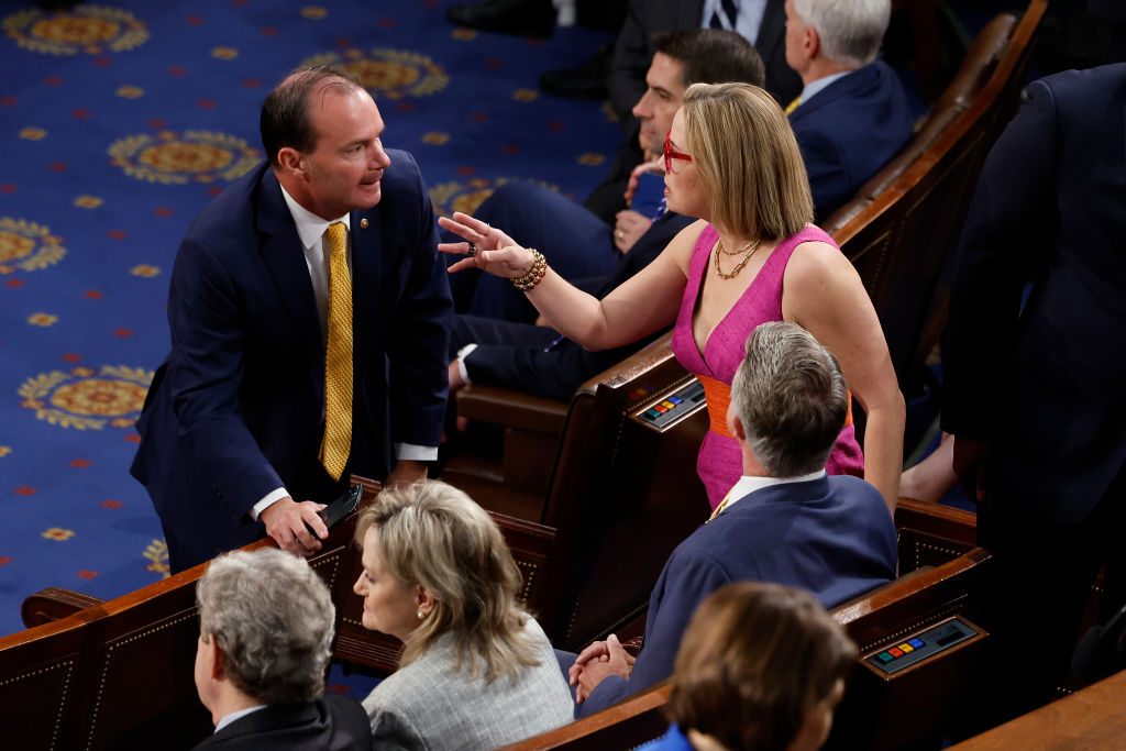 Sen. Mike Lee (R-UT) (L) talks with Sen. Kyrsten Sinema (I-AZ) before Israeli President Isaac Herzog addresses a joint meeting of the U.S. Congress at the U.S. Captiol on July 19, 2023 in Washington, DC. Herzog