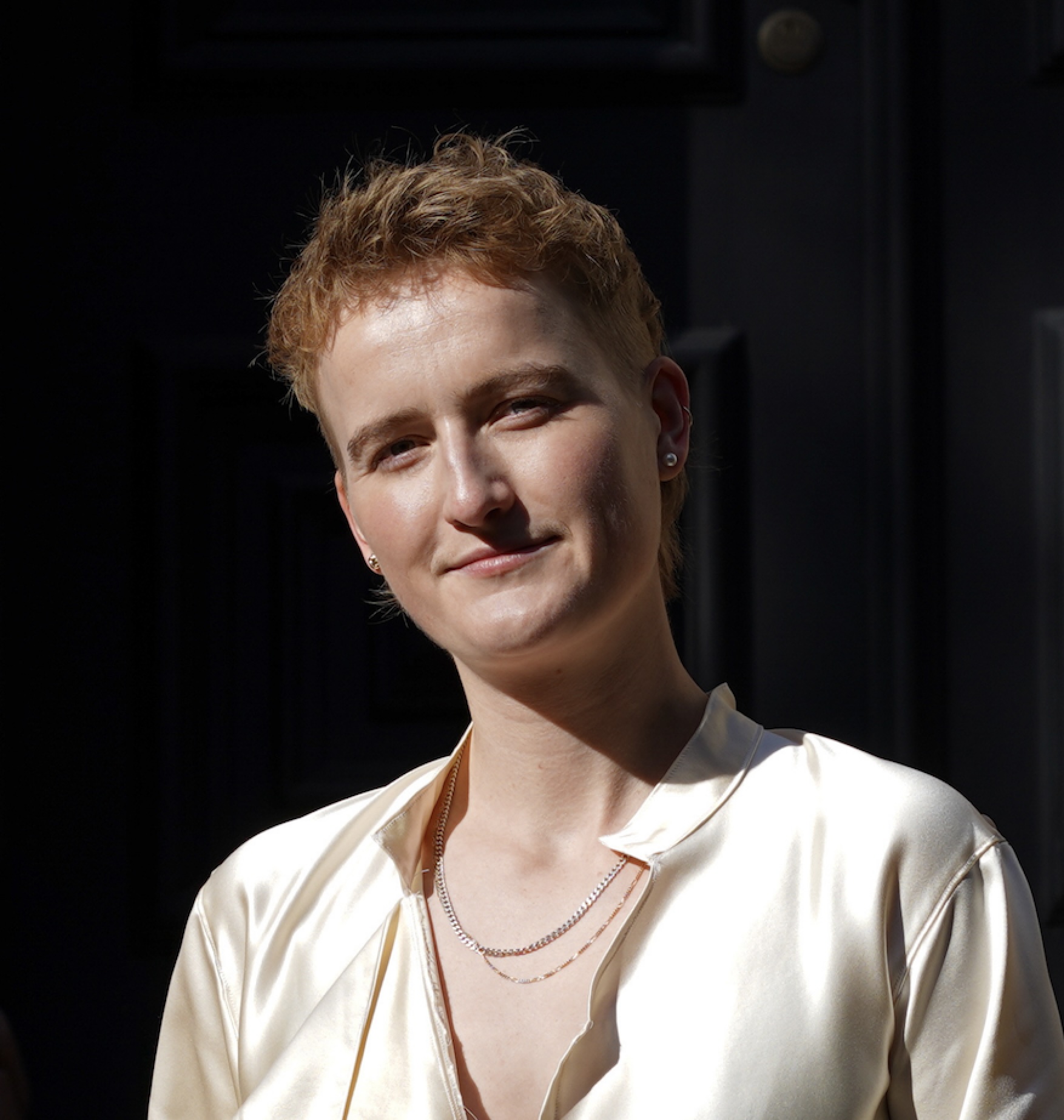 This is an image of non-binary tech founder Indy Sanders. They are wearing a white shirt
