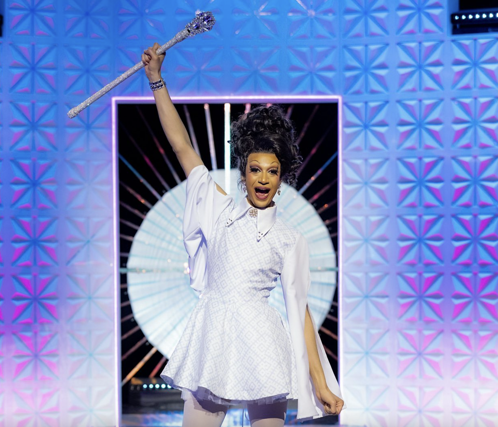 Drag Race UK vs The World season two winner Tia Kofi holding her sceptre in the air.