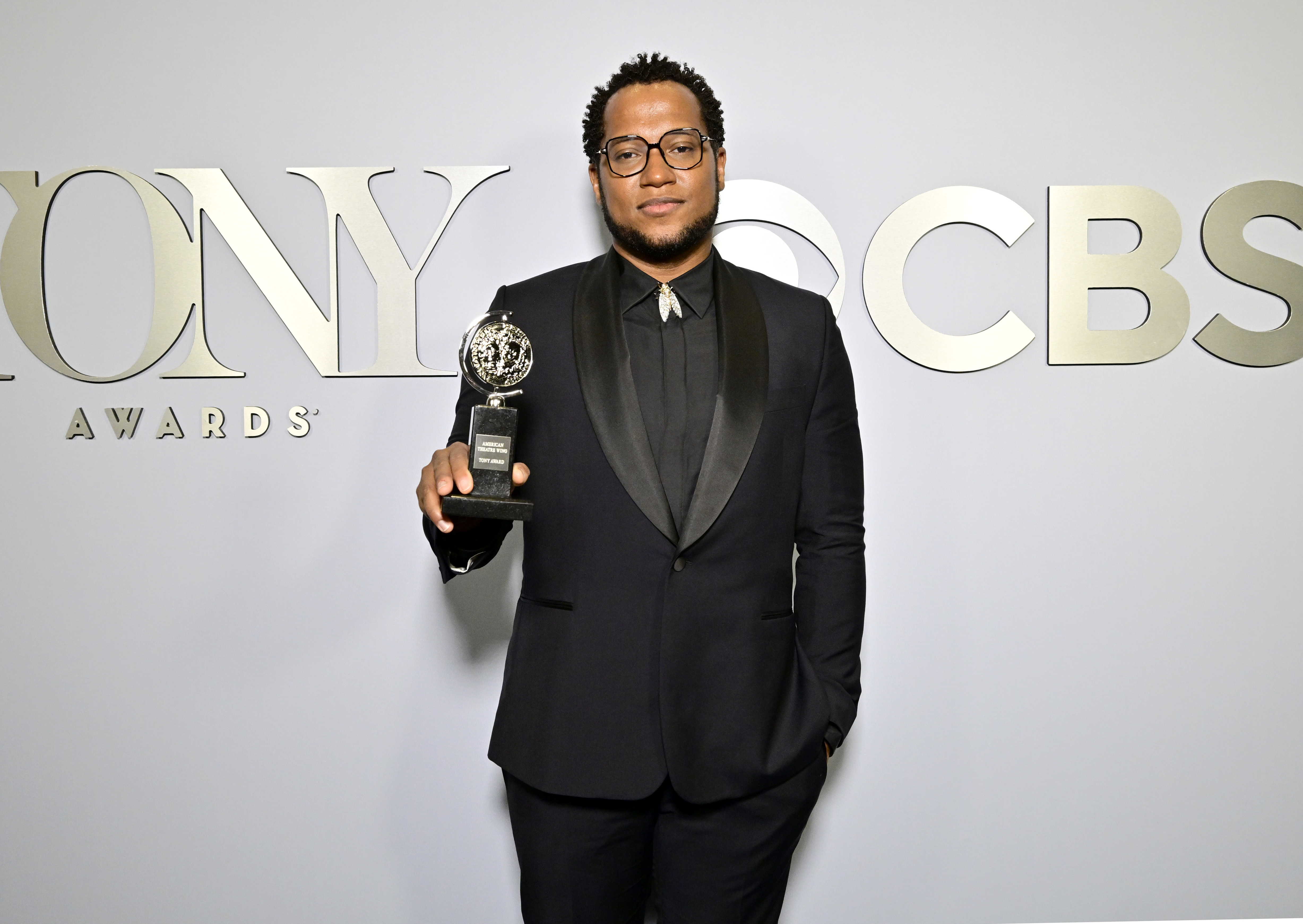 Branden Jacobs-Jenkins posing on the carpet with his Tony Award