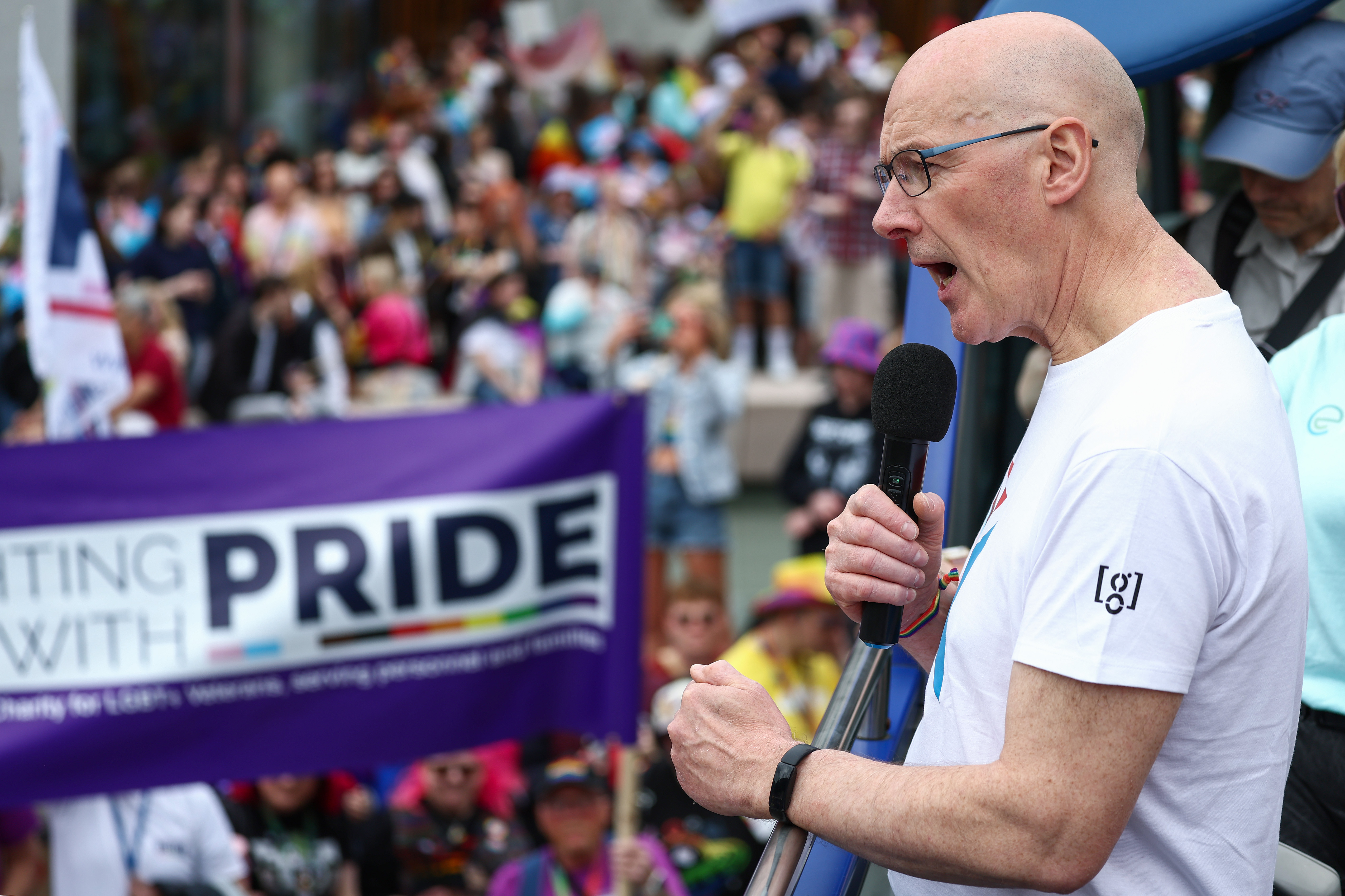 SNP Leader John Swinney waves to the crowd as he joins party activists on the Edinburgh Pride march in 2024.