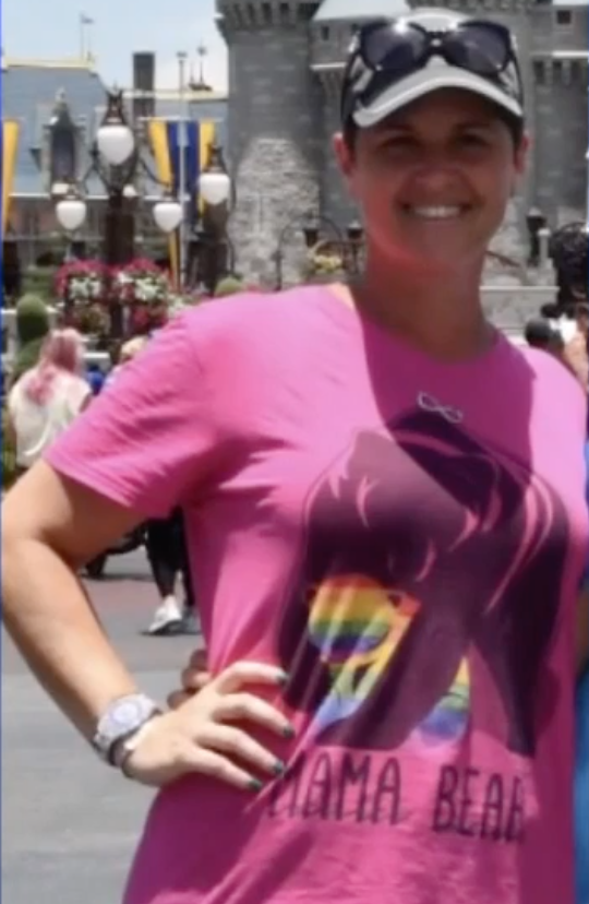 Jessica Norton at Disney World wearing a rainbow-themed pink &quot;Mama Bear&quot; t-shirt