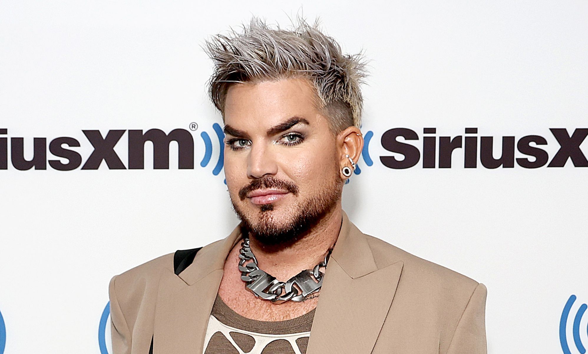 Adam Lambert poses while at SiriusX radio show.