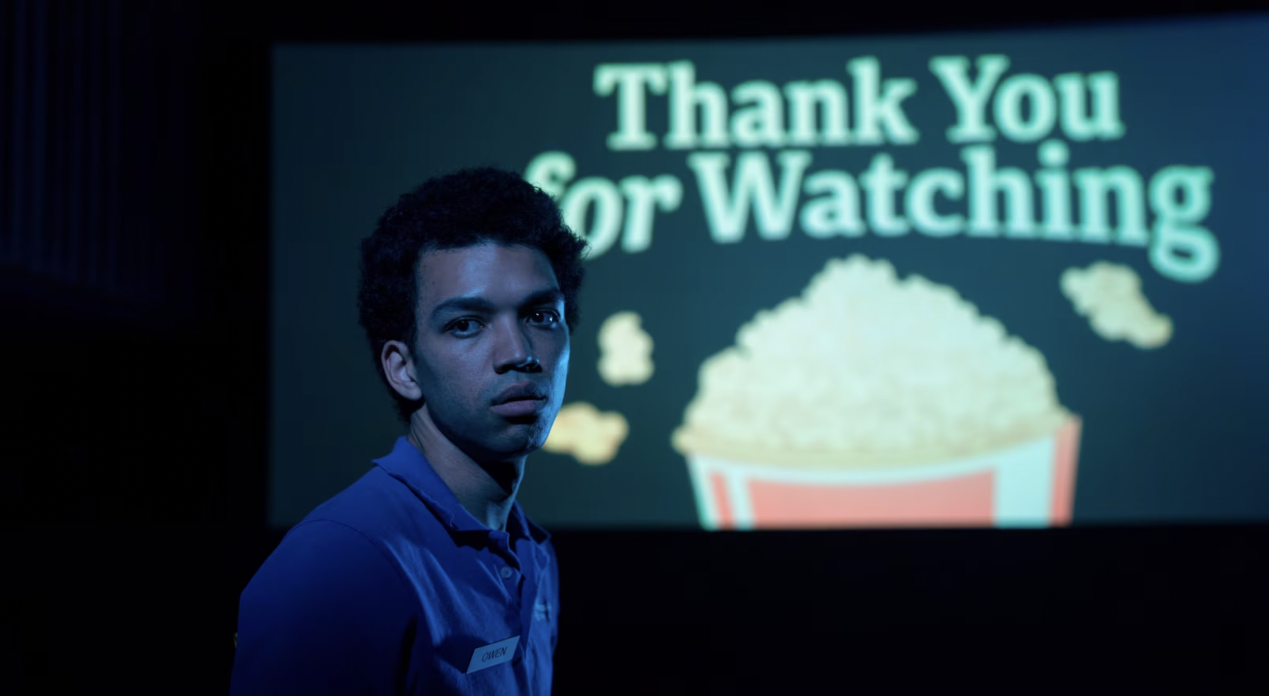 A still from I Saw The TV Glow featuring Owen looking away from a screen that reads &quot;Thank you for watching&quot;