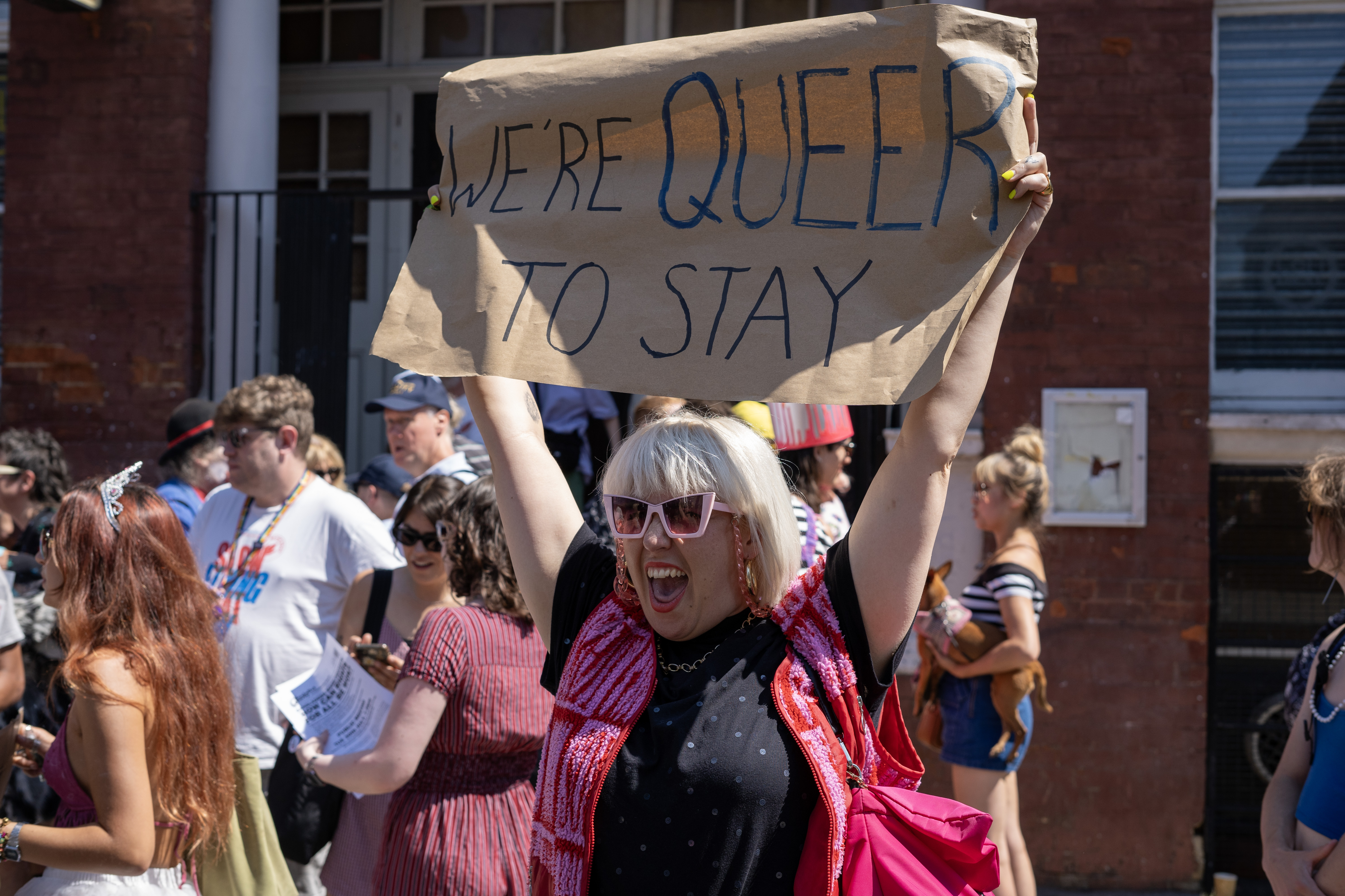 A protester holds a banner reading 