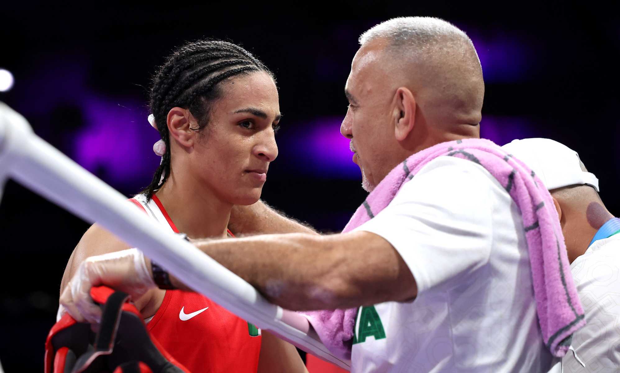 Imane Khelif of Team Algeria interacts with a coach of Team Algeria after Angela Carini of Team Italy (not pictured) abandons the Women