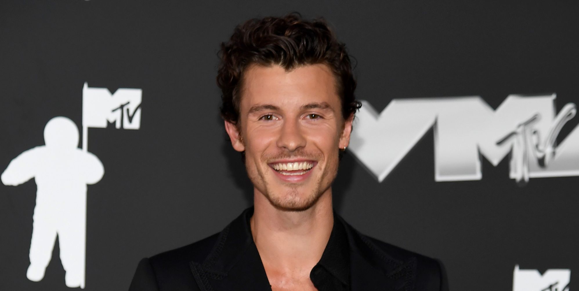 Shawn Mendes smiles on a red carpet