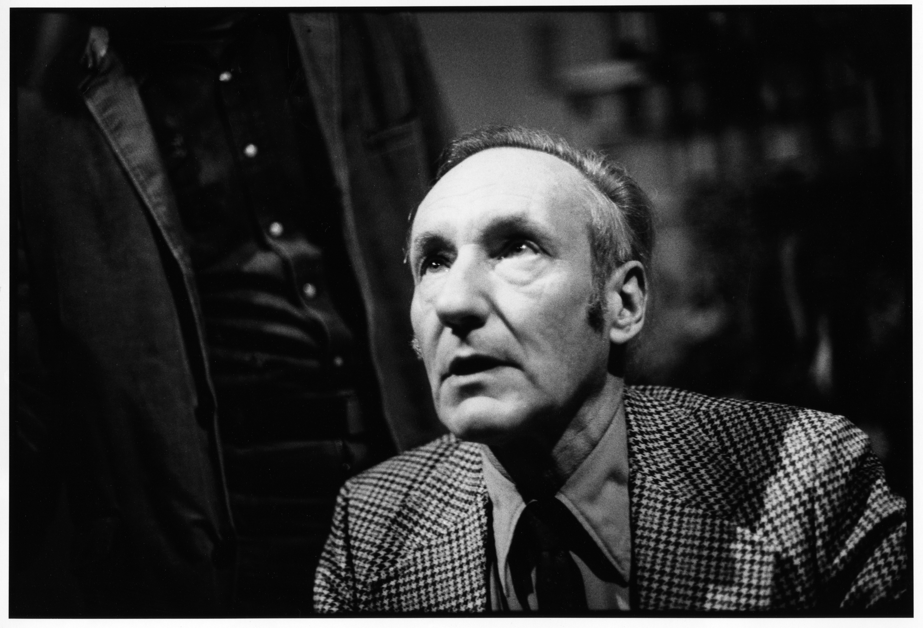 View of American author William S Burroughs looking up, shot from above