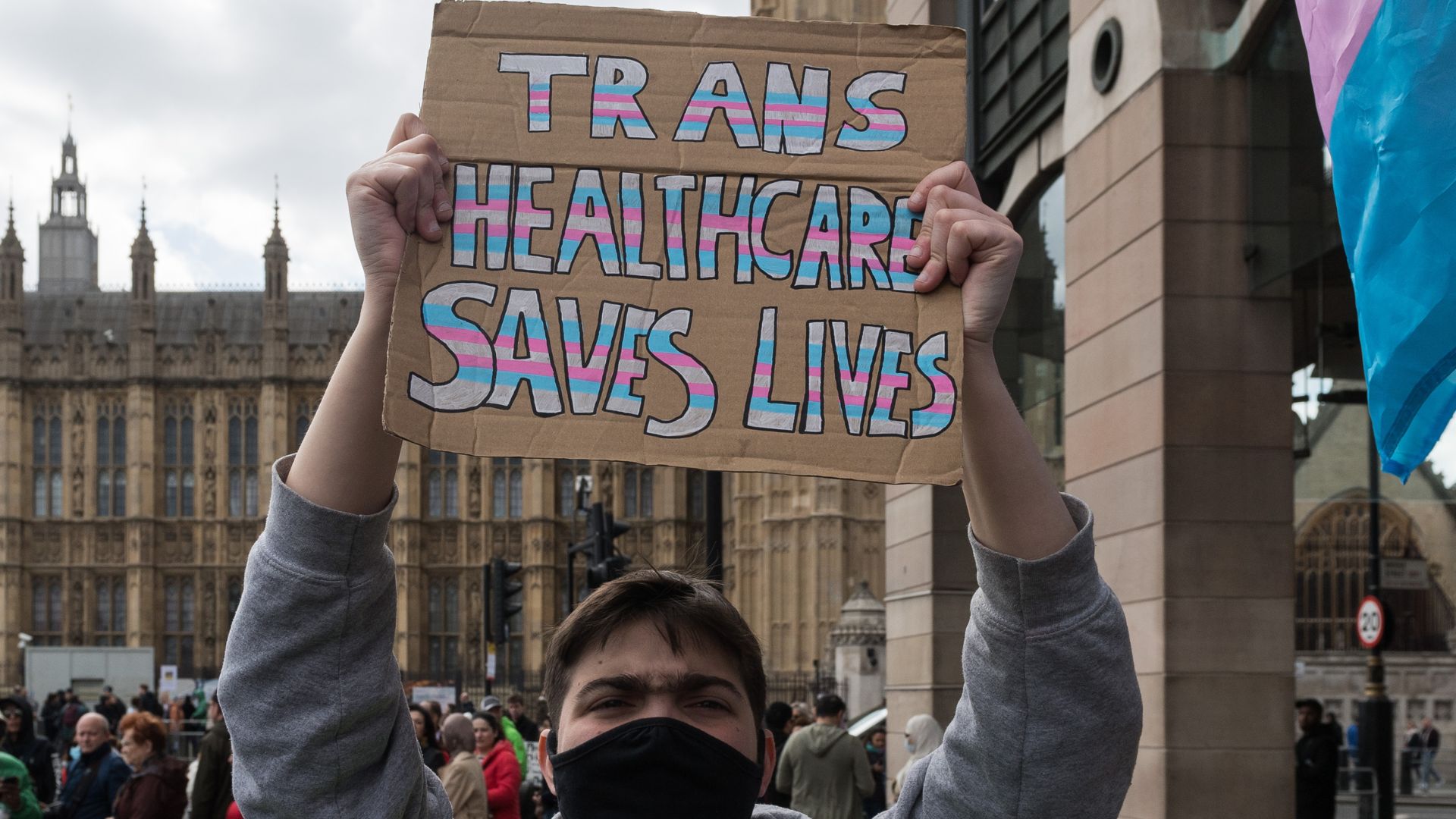 Protester in London holds up a placard reading &quot;trans healthcare saves lives&quot;