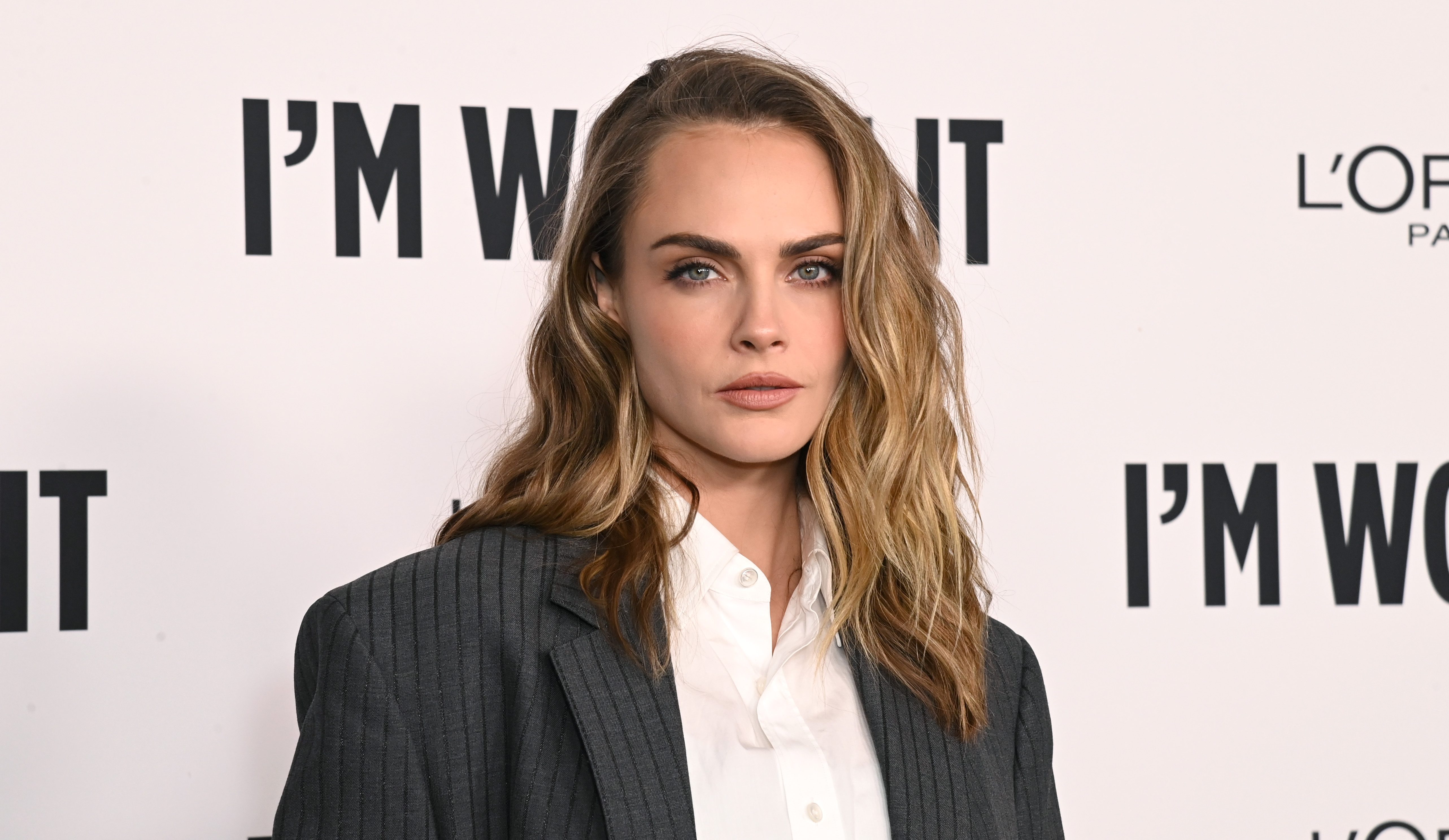 Fans gagged after Cara Delevingne undergoes Sir Elton John-inspired drag makeover in new music video